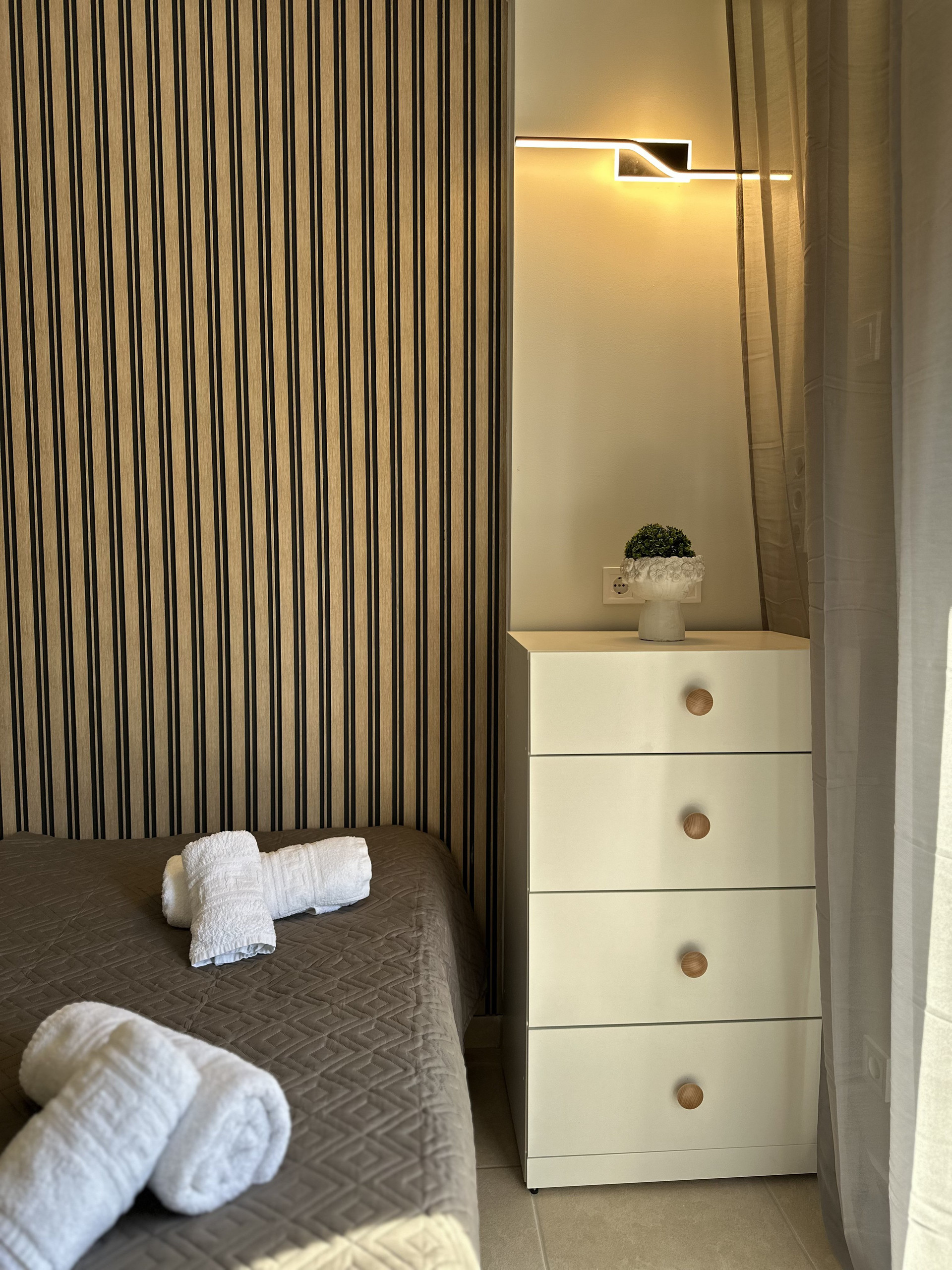 Bedroom detail with dresser and towels