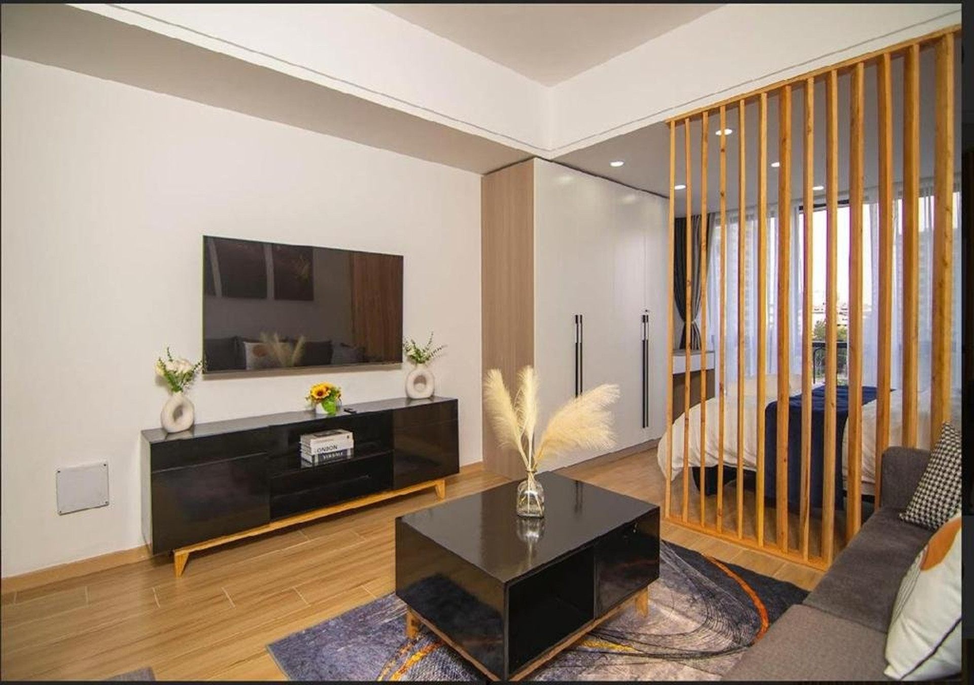 Living area with wooden slat divider