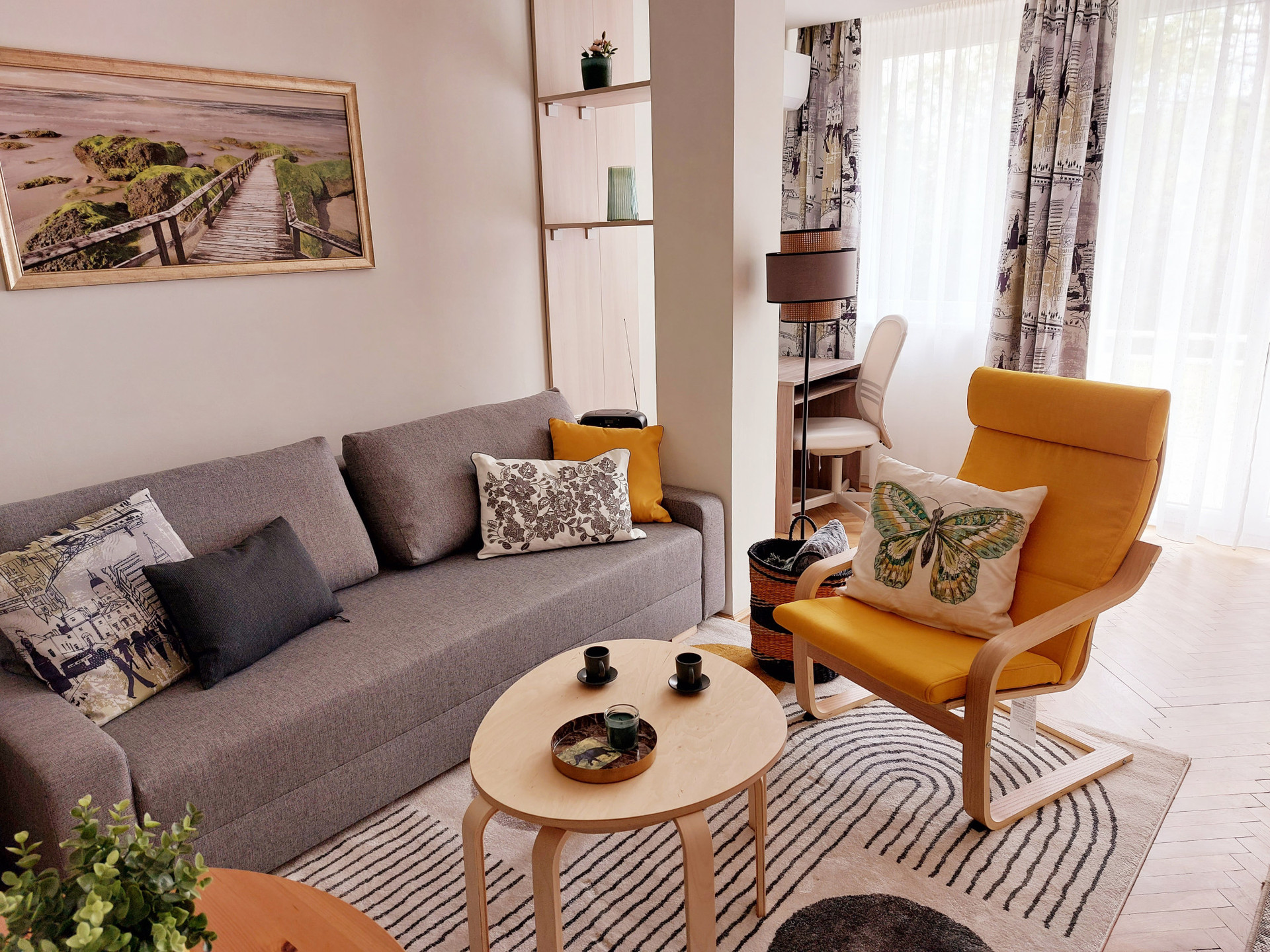 Cosy sofa and armchair with working corner in the background