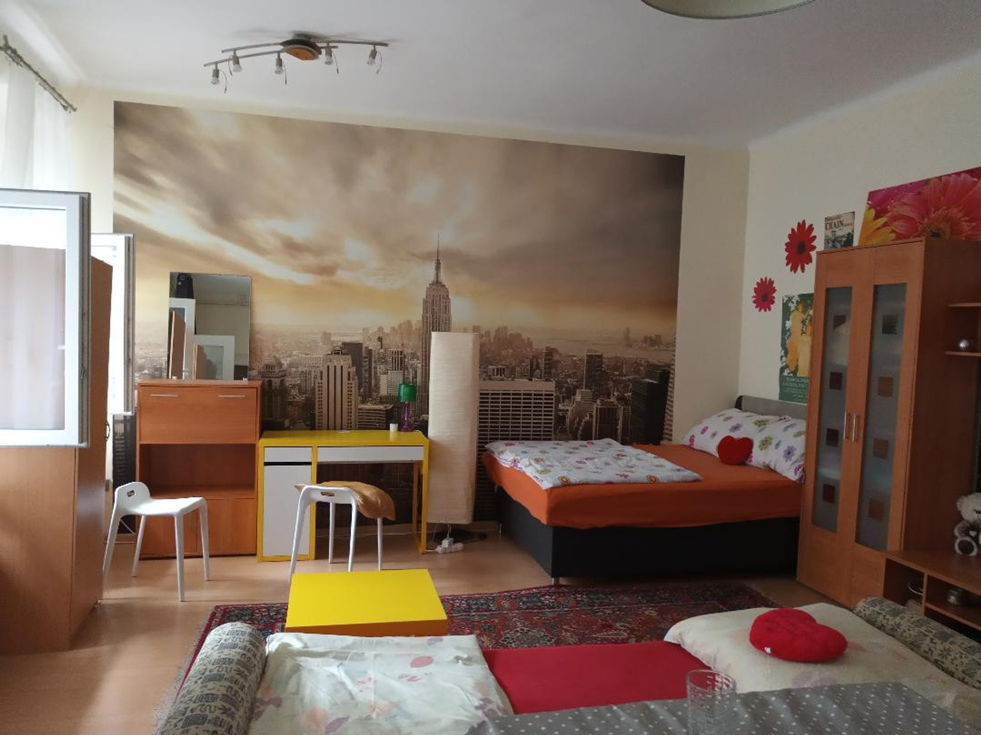 studio with desk and sofa and double bed 