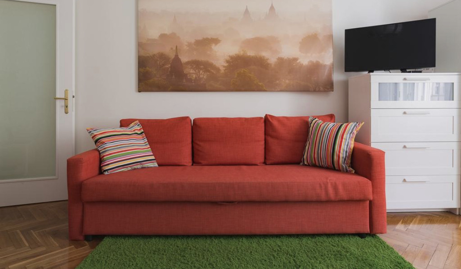 Red sofa with TV and dresser