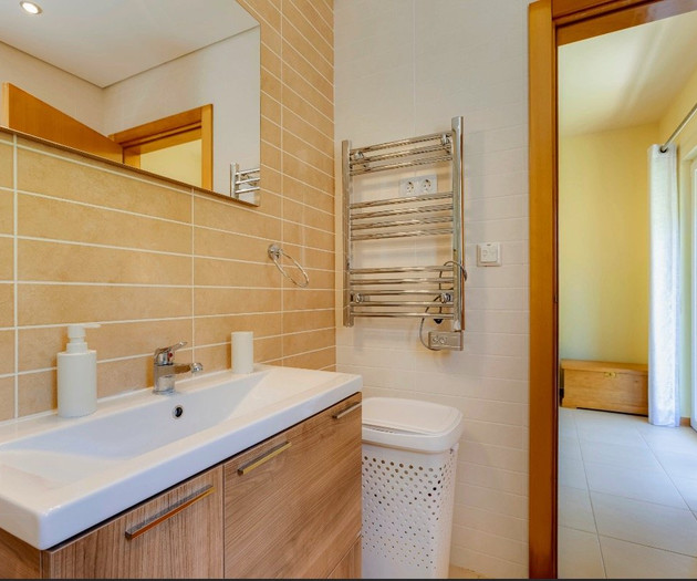 Bathroom with vanity and towel rail