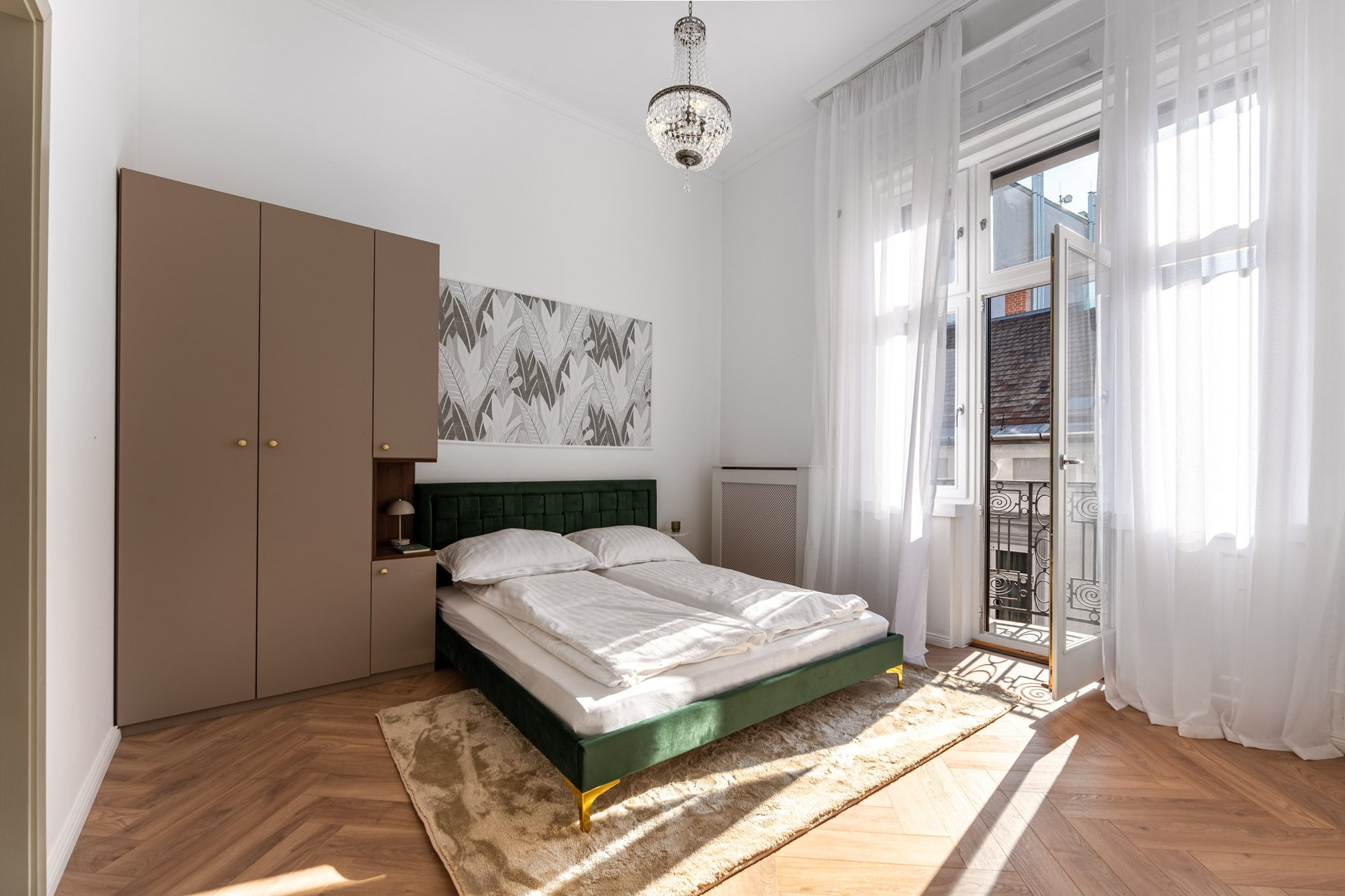 Bright bedroom with green velvet bed