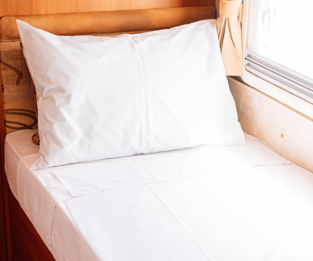 Single bed with white linen