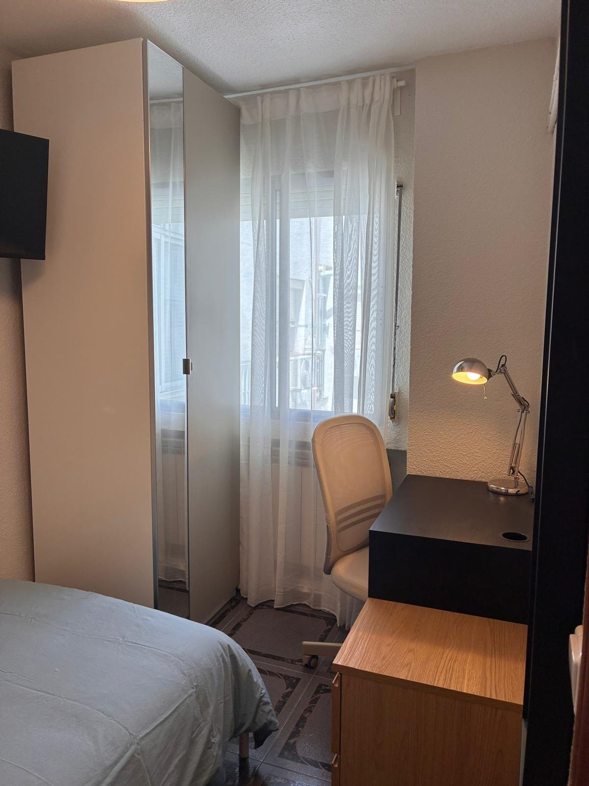 Bedroom desk with lamp and chair