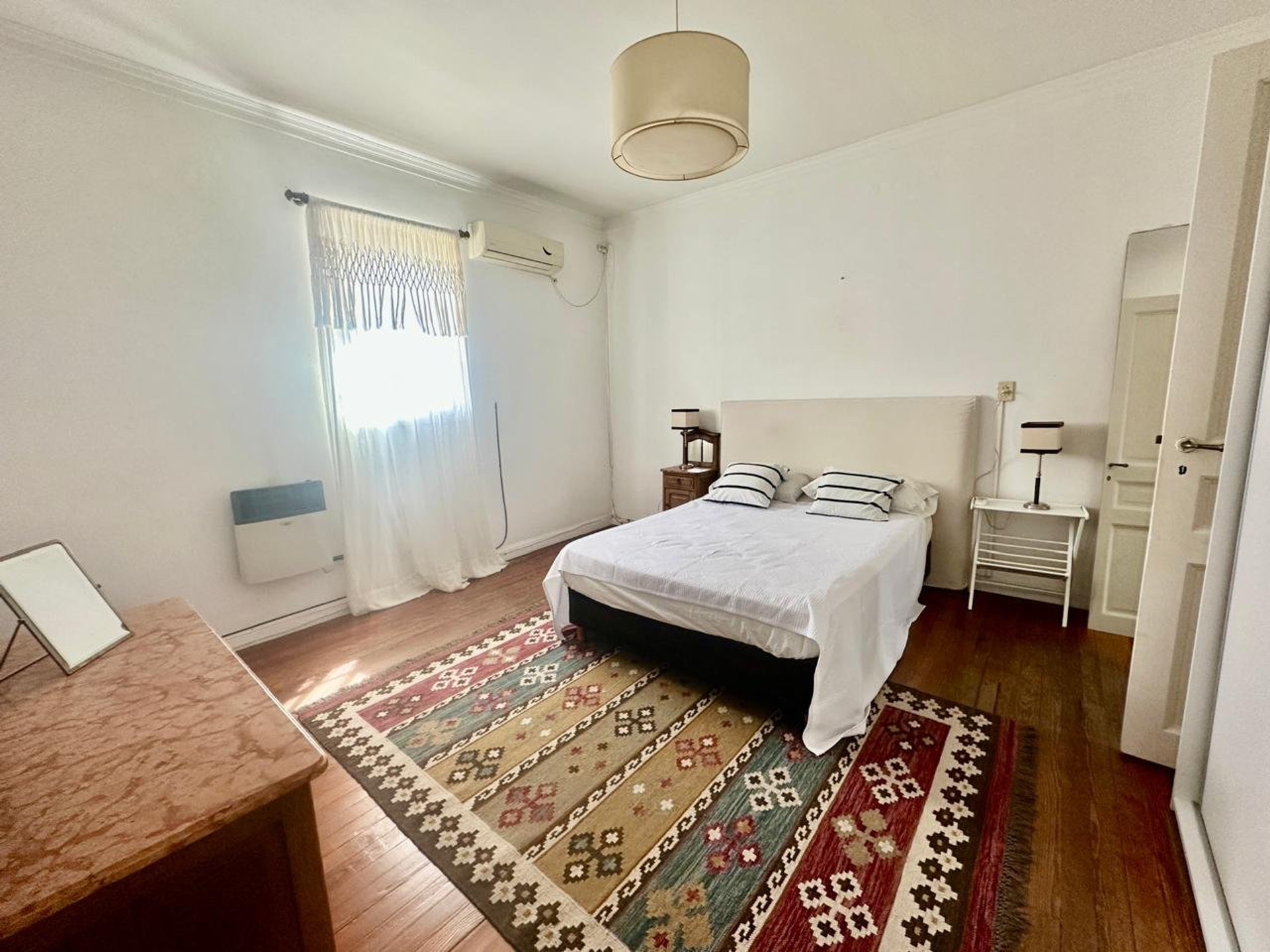 Master bedroom with colorful rug