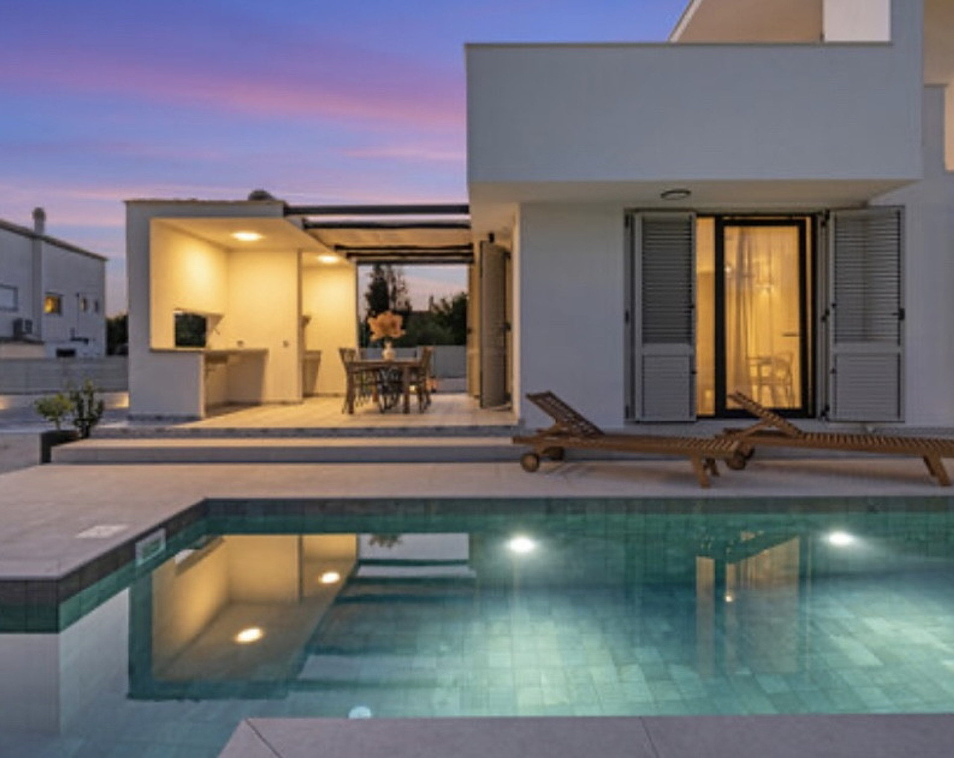 Pool and villa at dusk