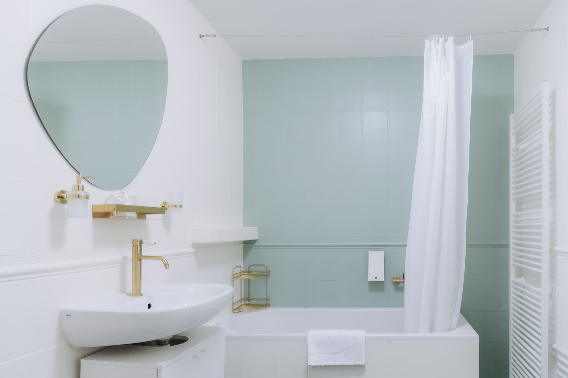 Bathroom with tub and mirror