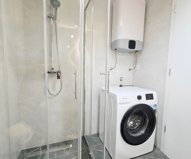 Bathroom with shower and washing machine