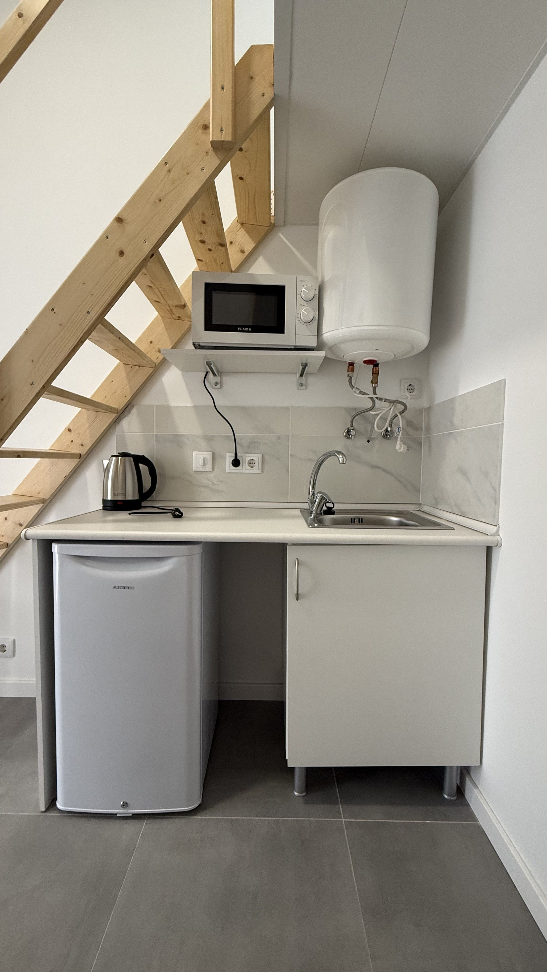 Compact kitchenette with sink and appliances