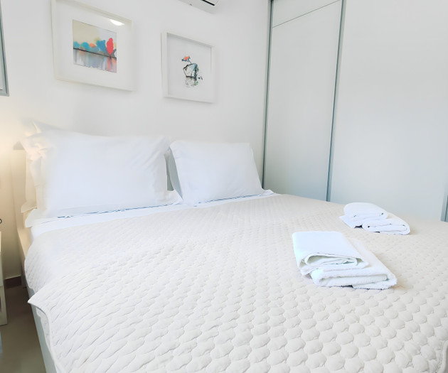 Bedroom with artwork and bed