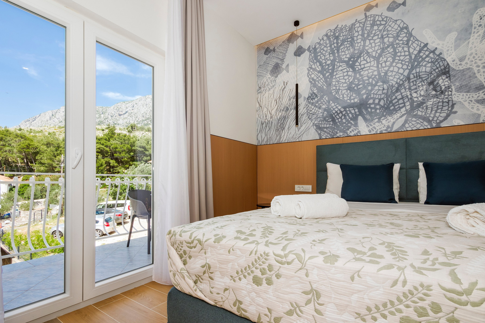 Bedroom with balcony door, mountain view