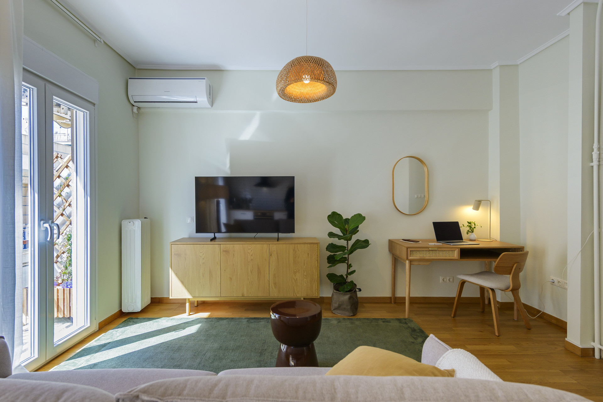 Living area with a dedicated workspace and balcony access