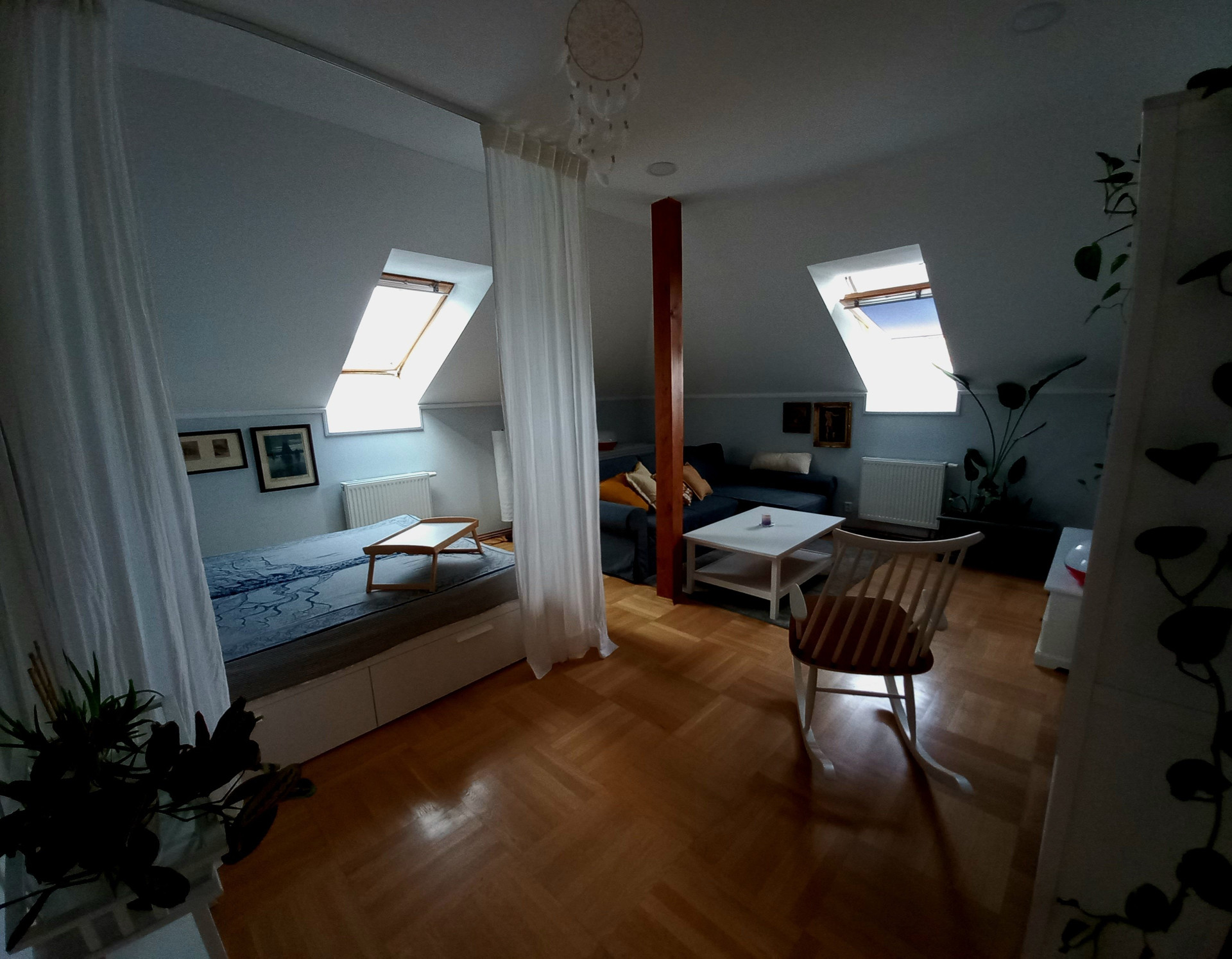 Attic living area with bed and sofa