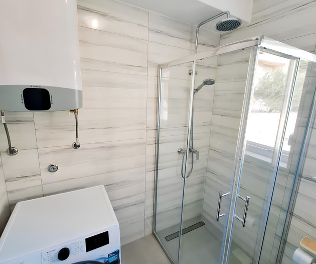 Bathroom with shower and washer