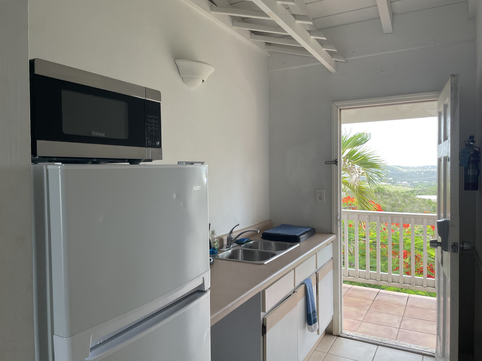 Compact kitchenette with balcony access