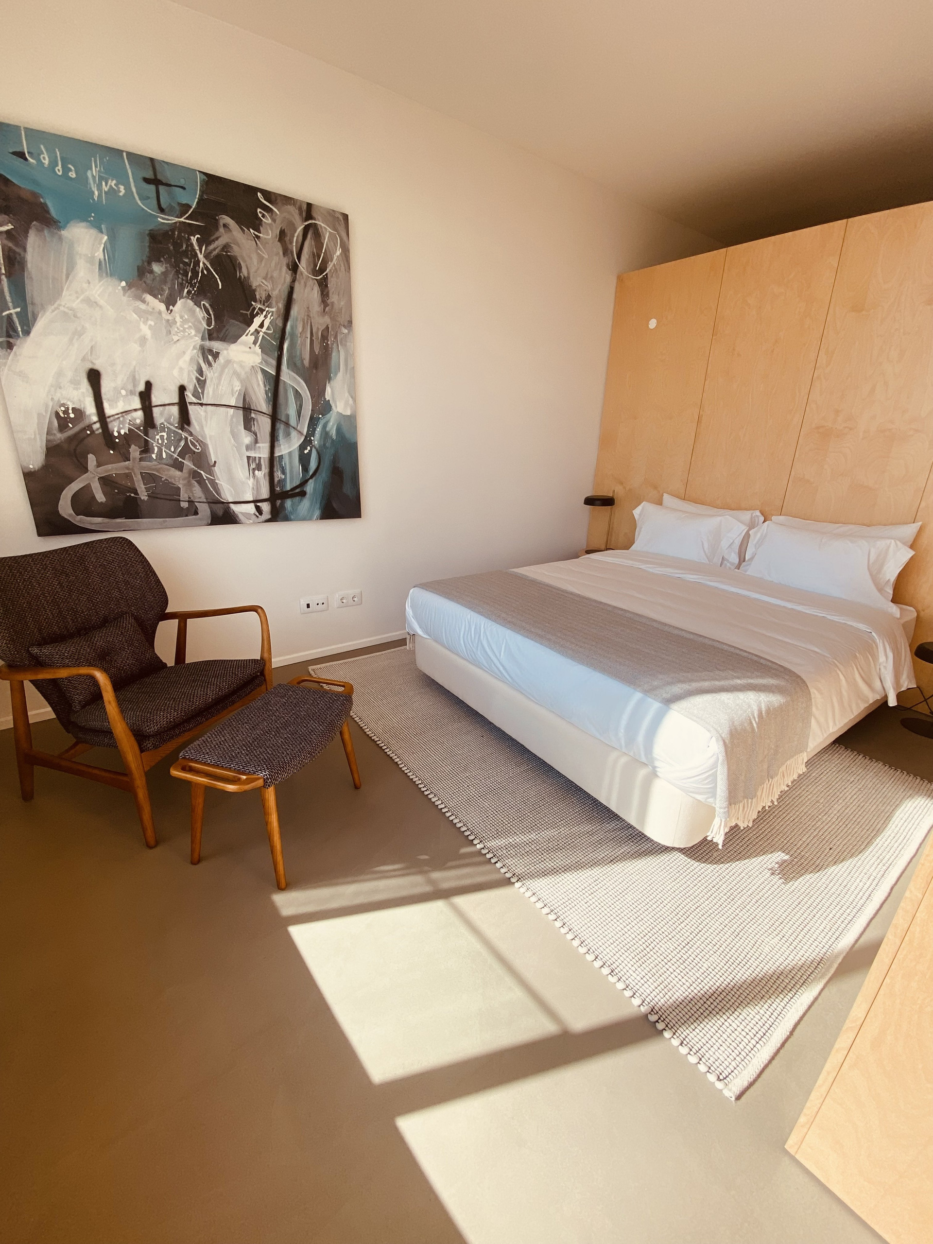Bedroom with double bed and artwork