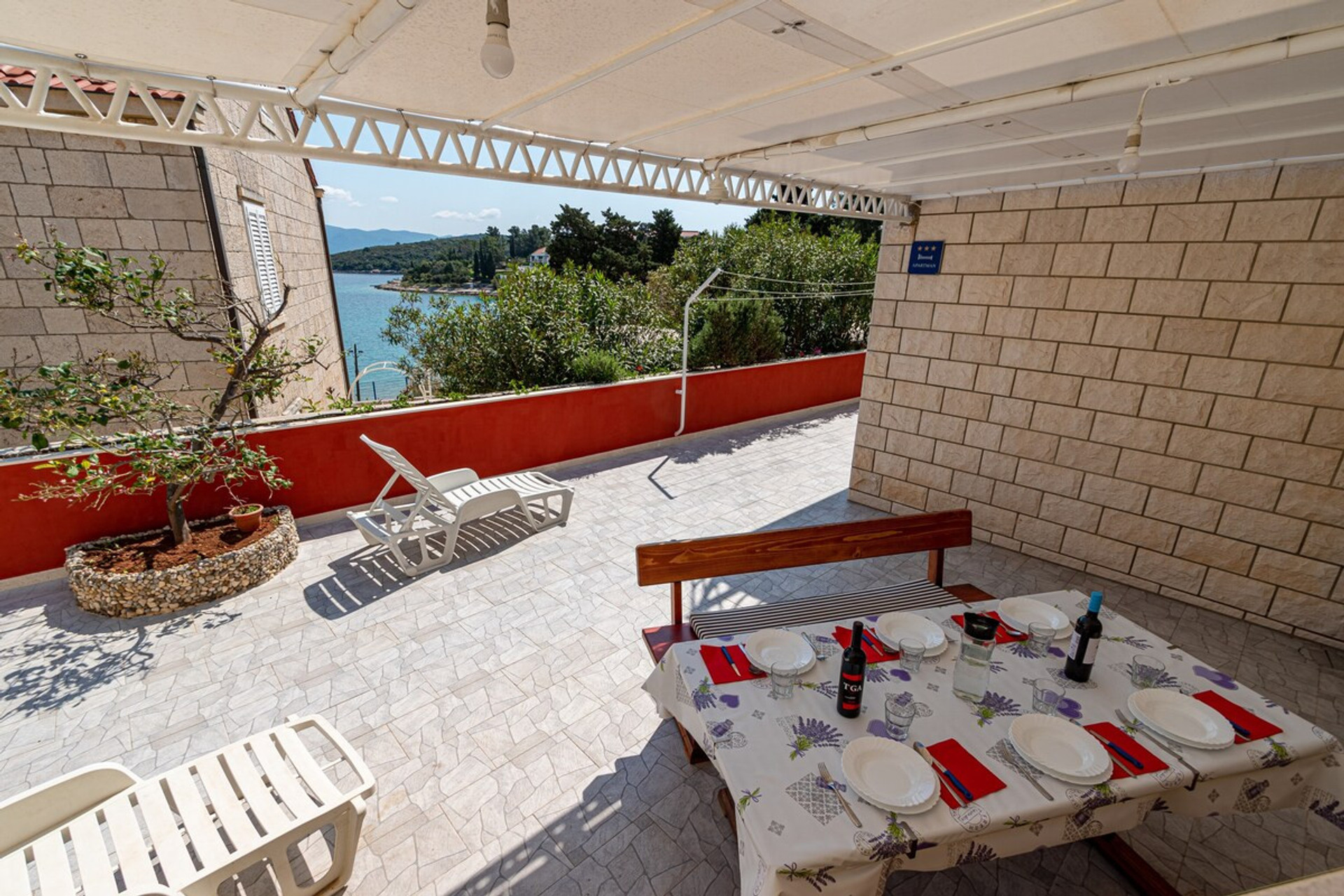 Terrace with sun loungers and sea view 