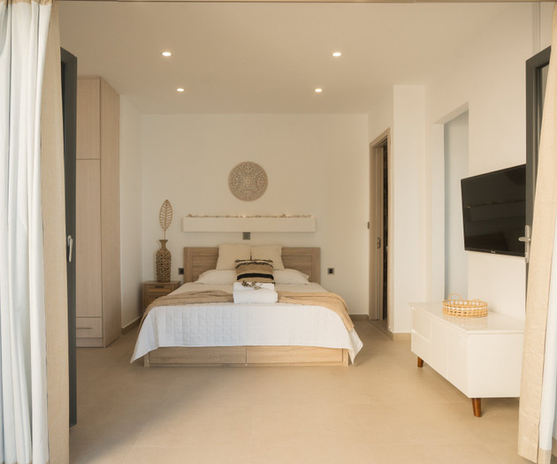 Bedroom with TV through curtains