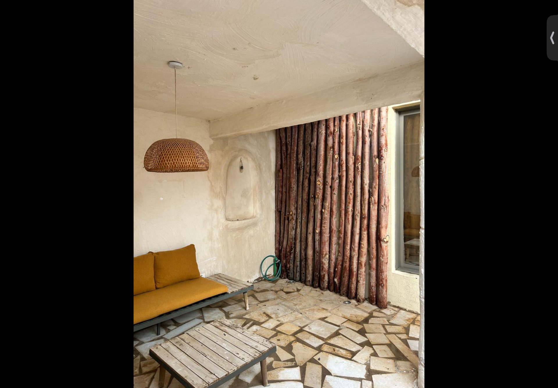 Courtyard seating with wooden log wall