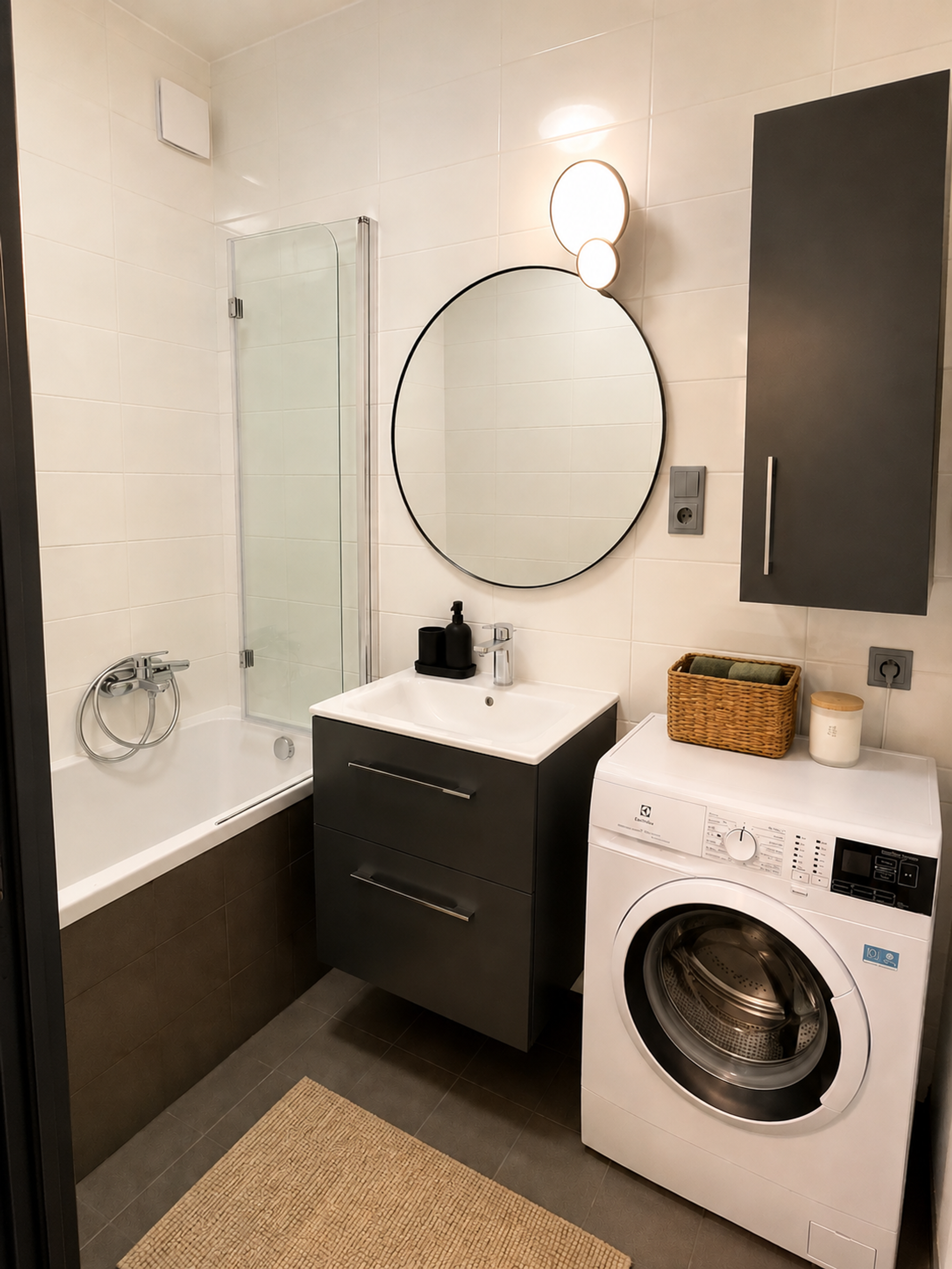 Bathroom with bathtub and washer