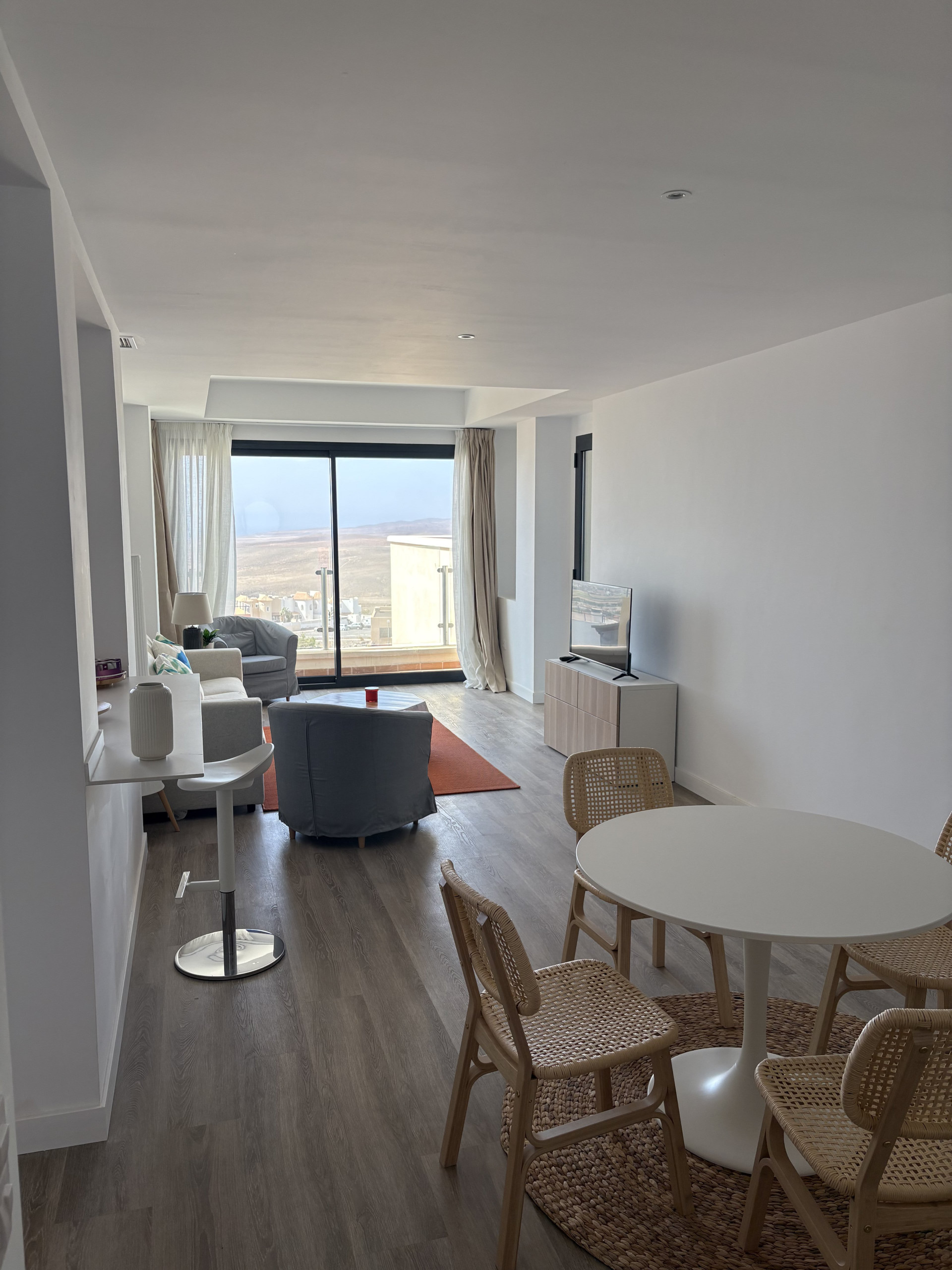 Living room with dining and balcony view