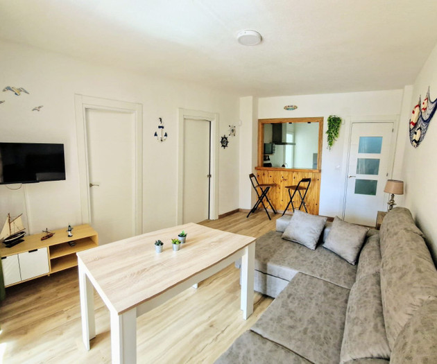 Living room with TV and hallway view