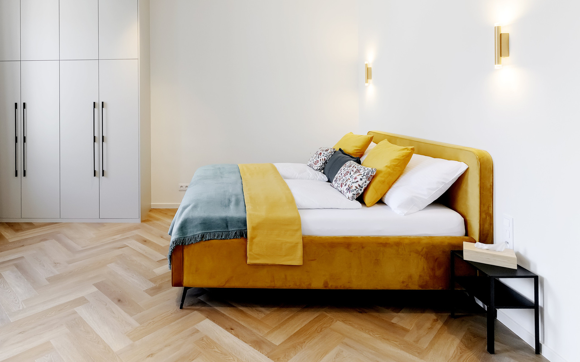 Bright bedroom with yellow velvet bed