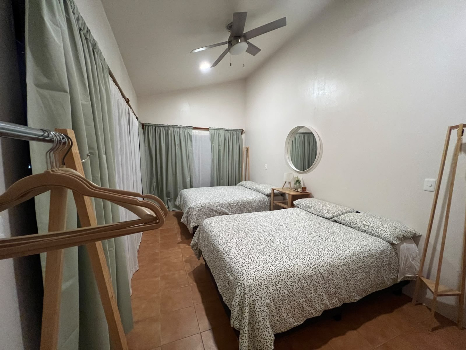 Twin bedroom with beds and mirror