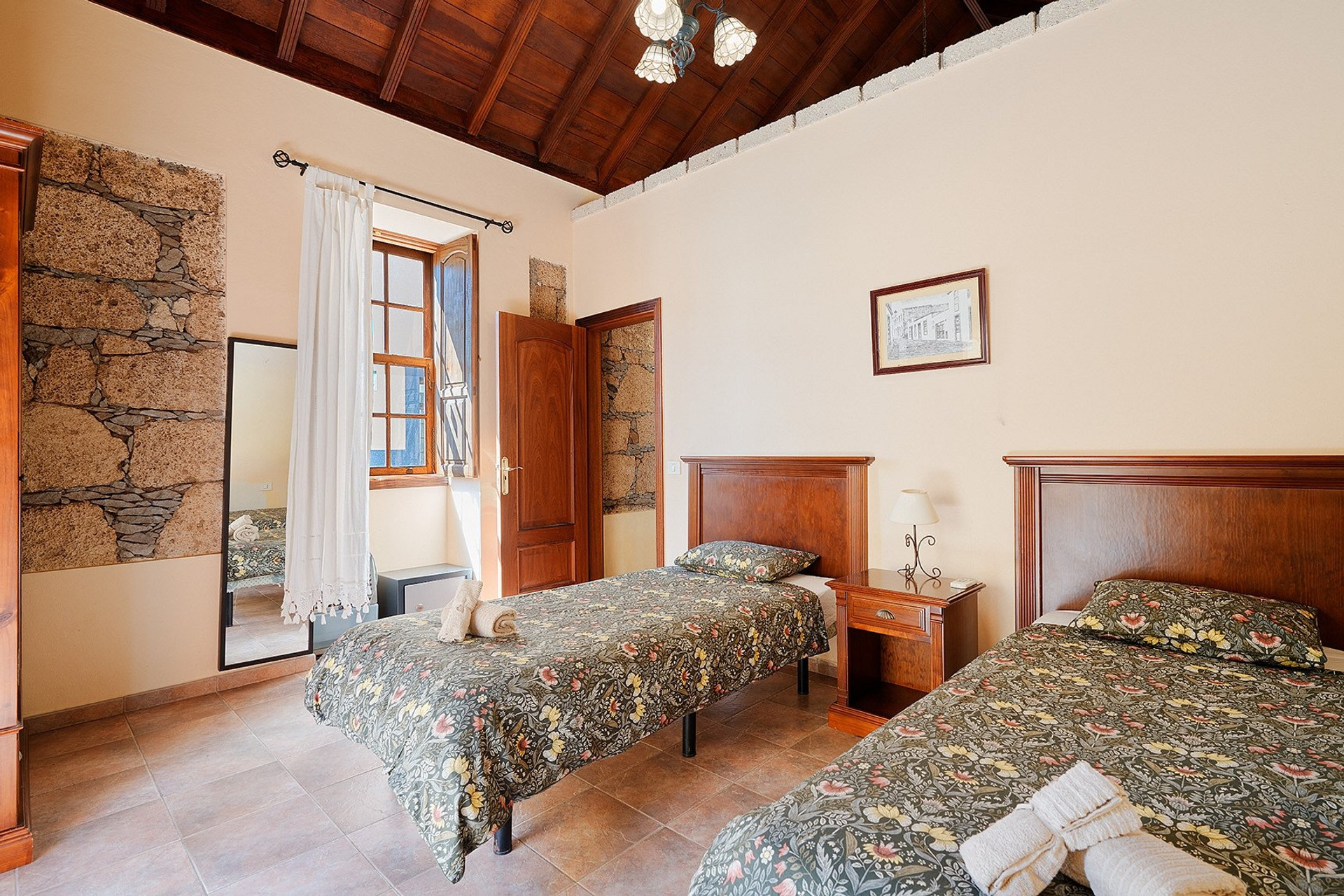 Twin bedroom with stone wall