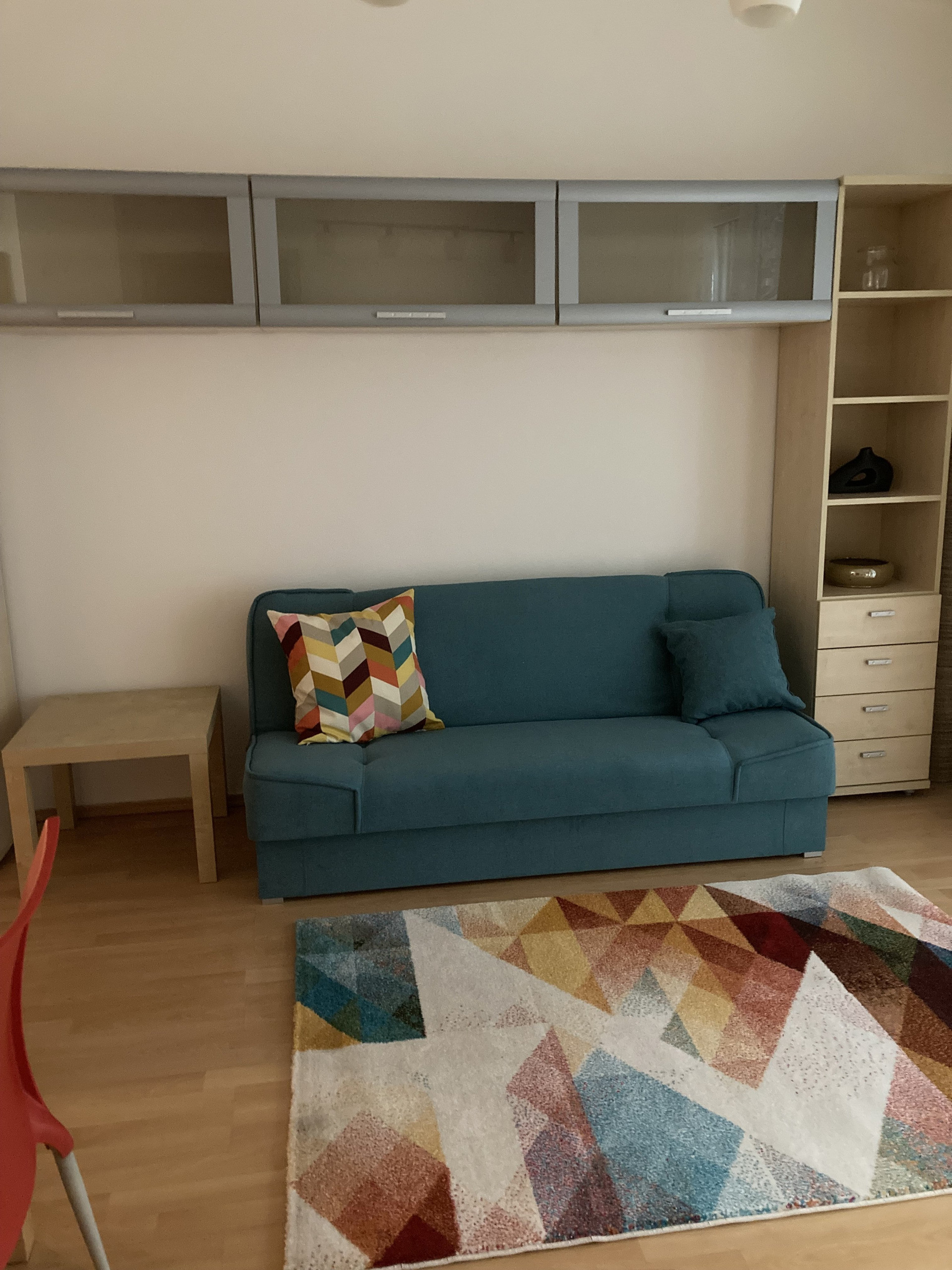 Sofa bed with colorful rug