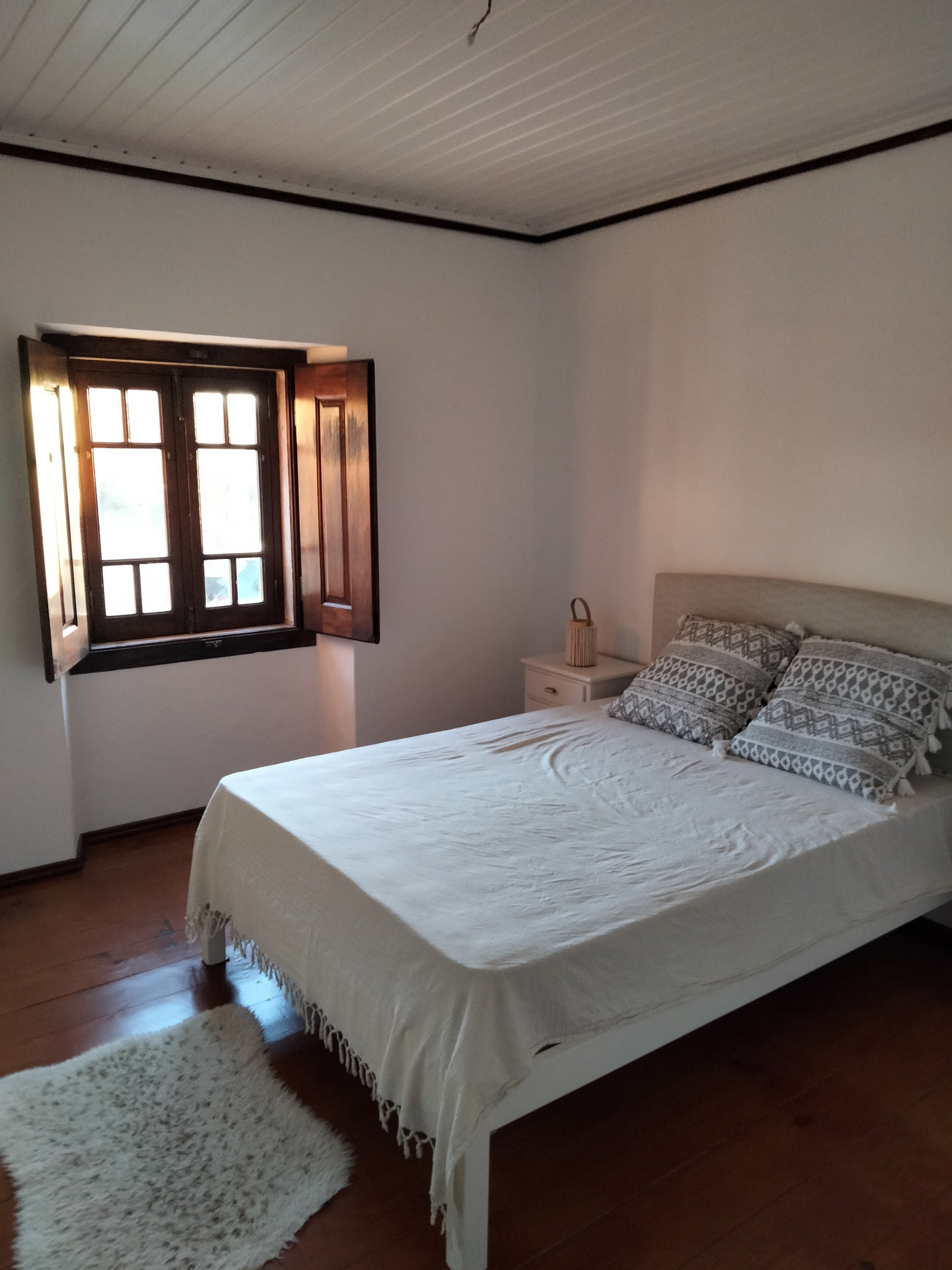 Bedroom with double bed, wooden floor