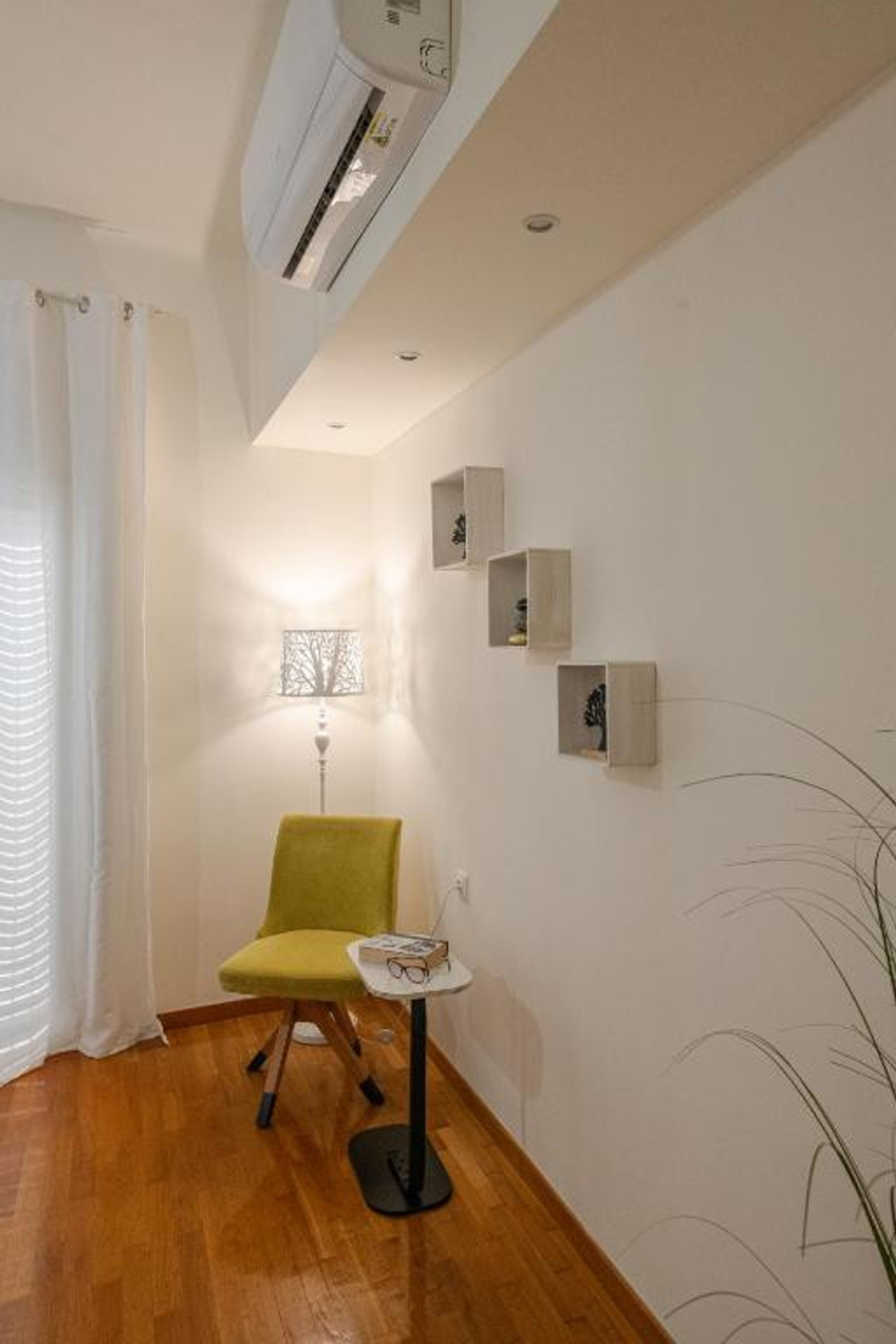 Reading corner green chair wall shelves