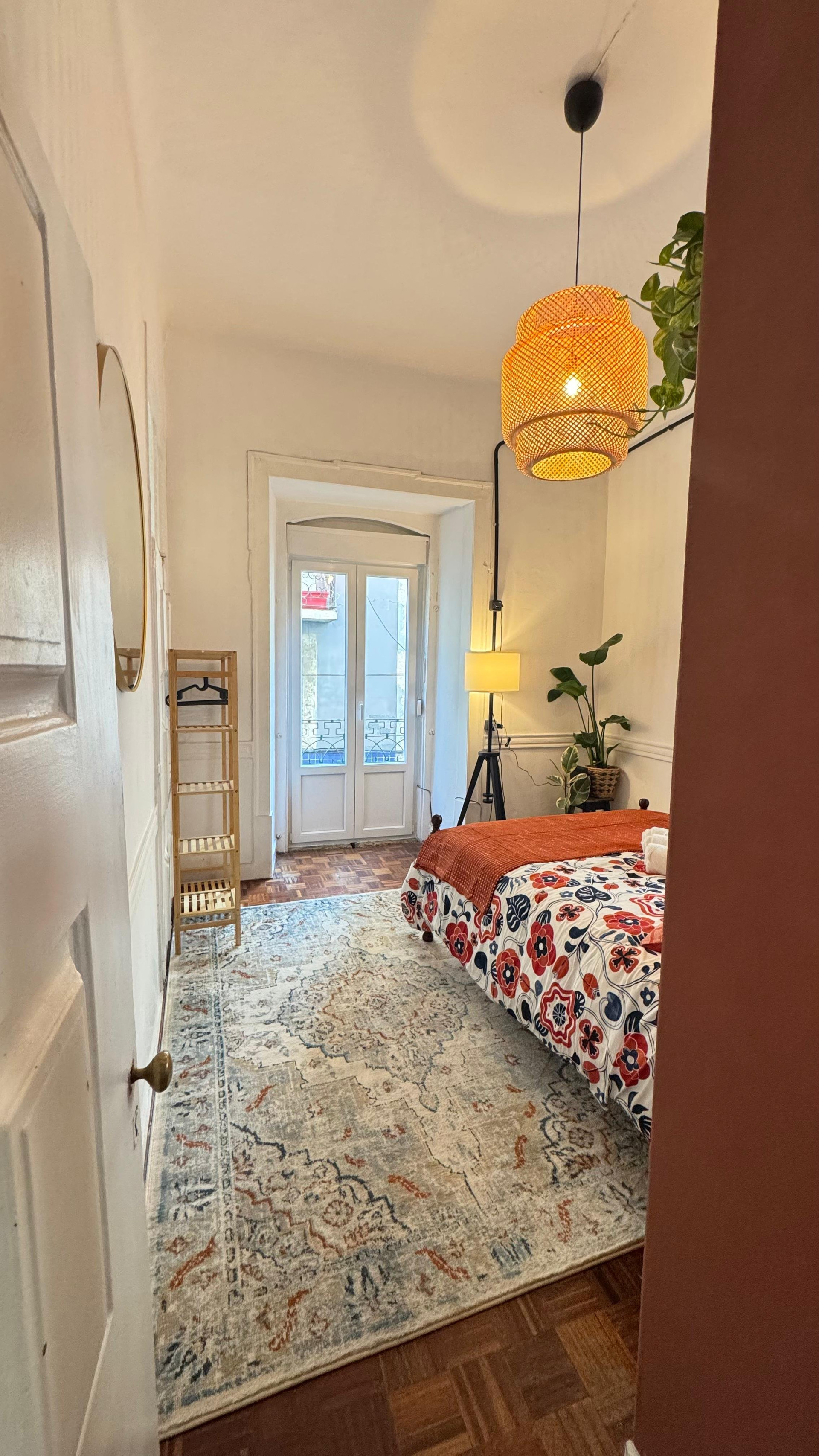 Bedroom with patterned rug and balcony door