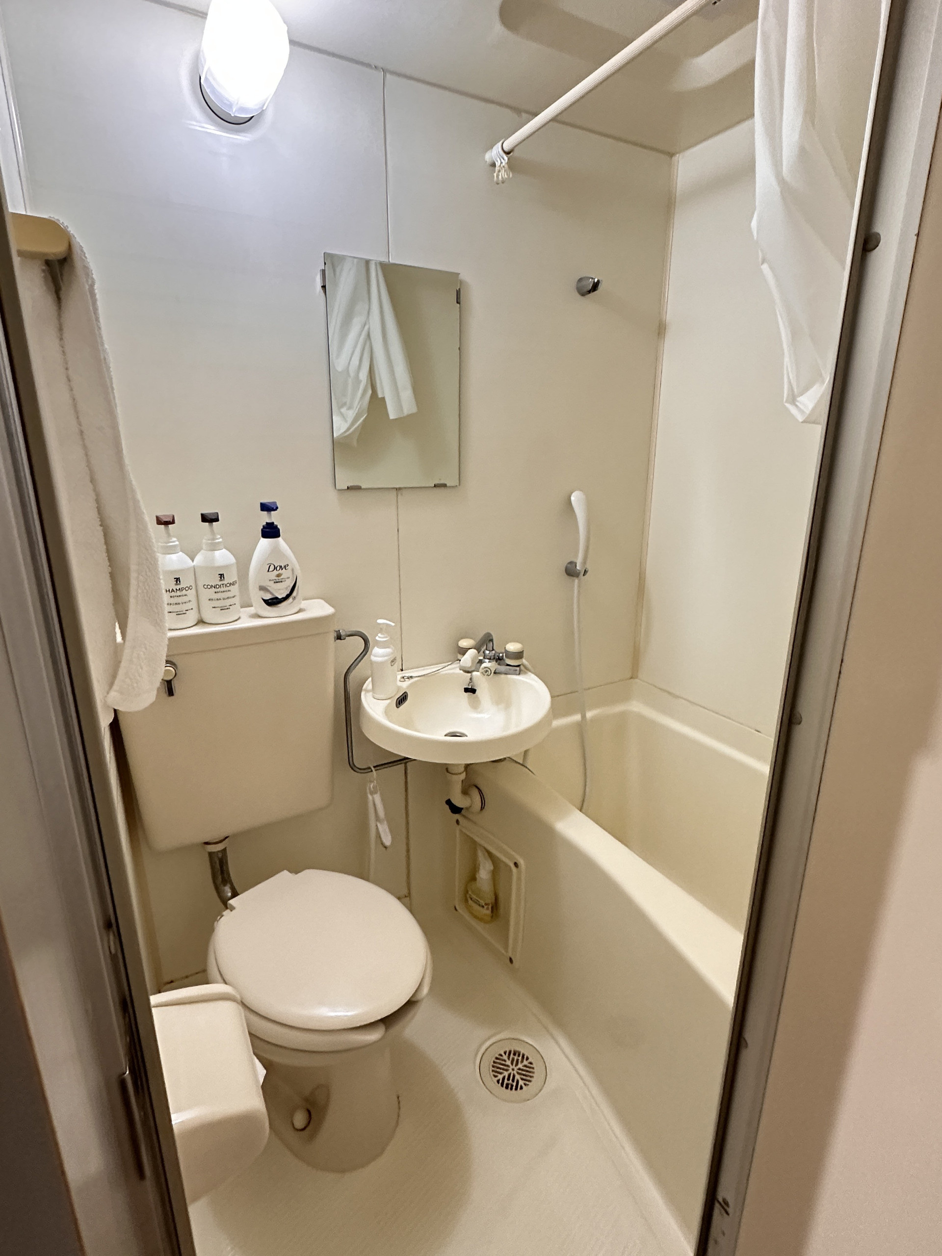 Compact bathroom with tub toilet