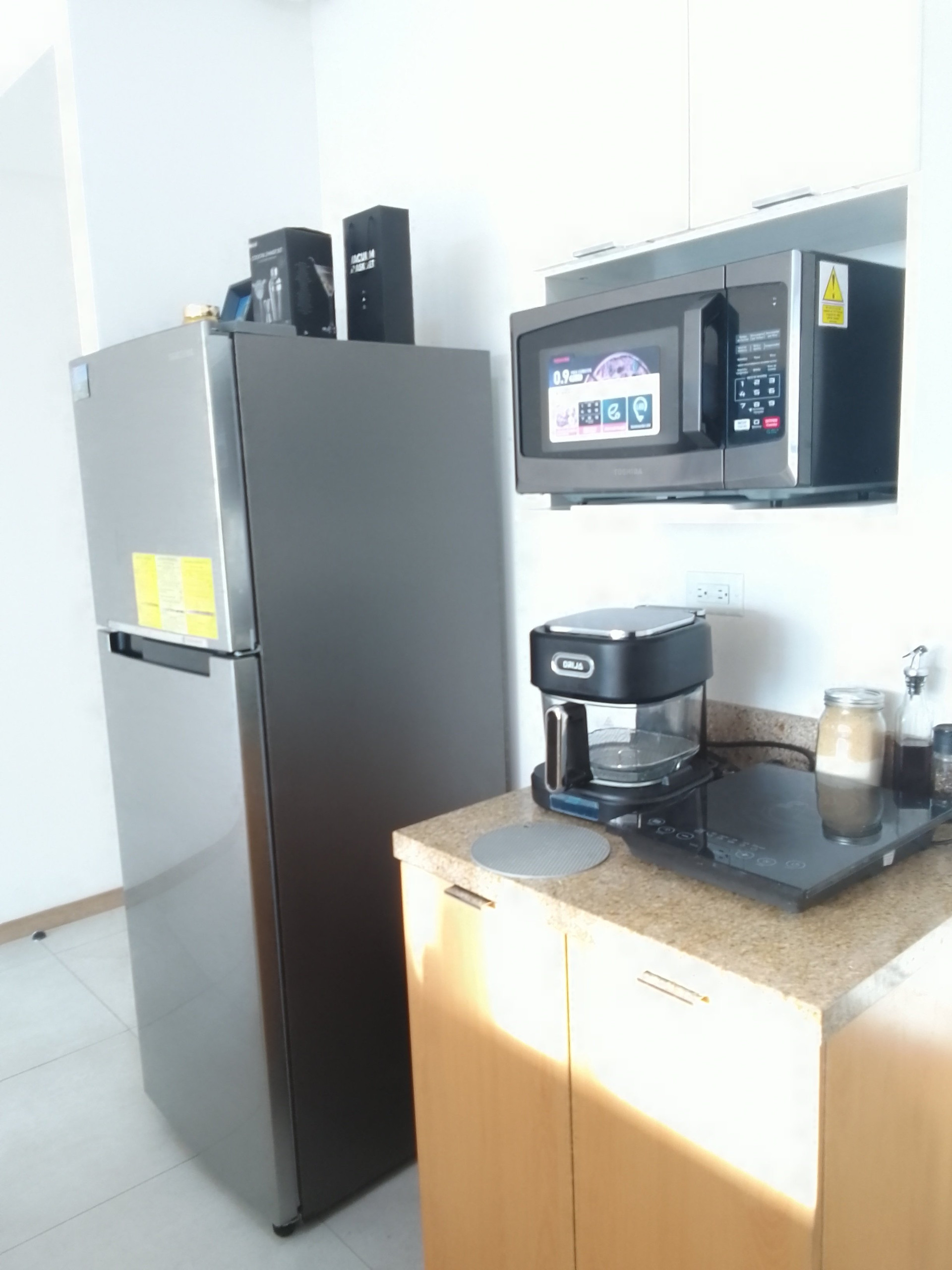 Kitchen with fridge and microwave