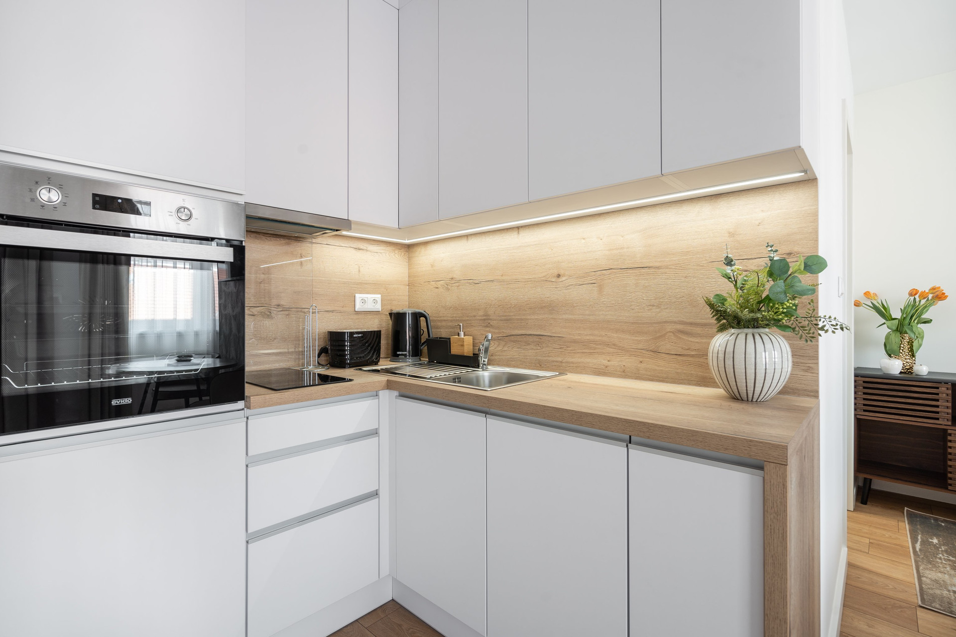 Modern white kitchen with wood countertops