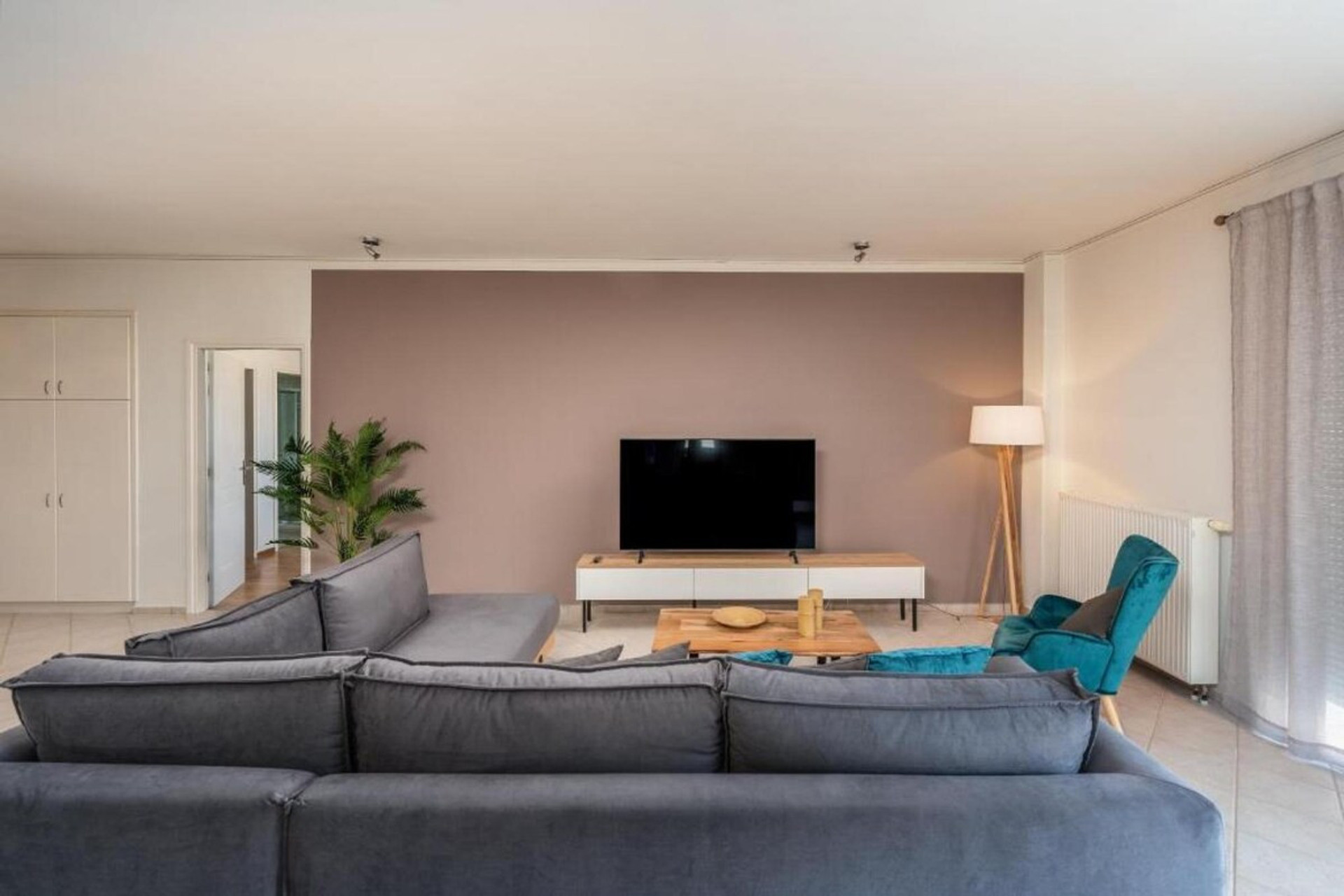 Living room view, large sofa, large TV.