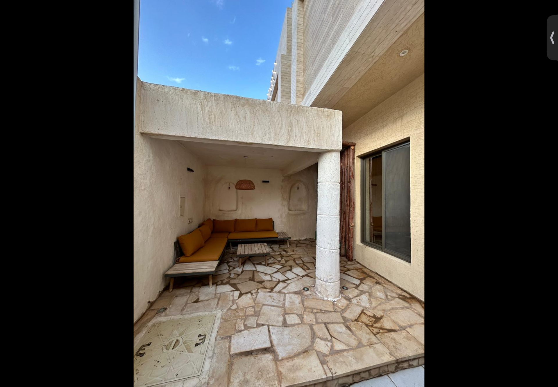 Covered patio with orange sofa