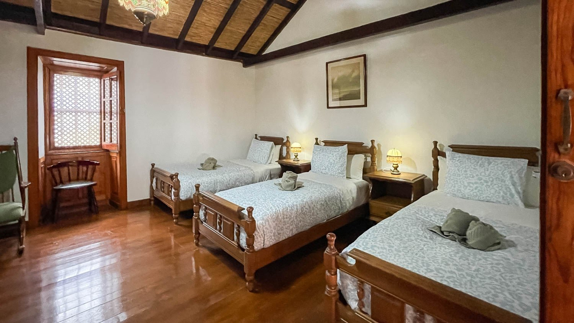 Triple bedroom with wooden floors