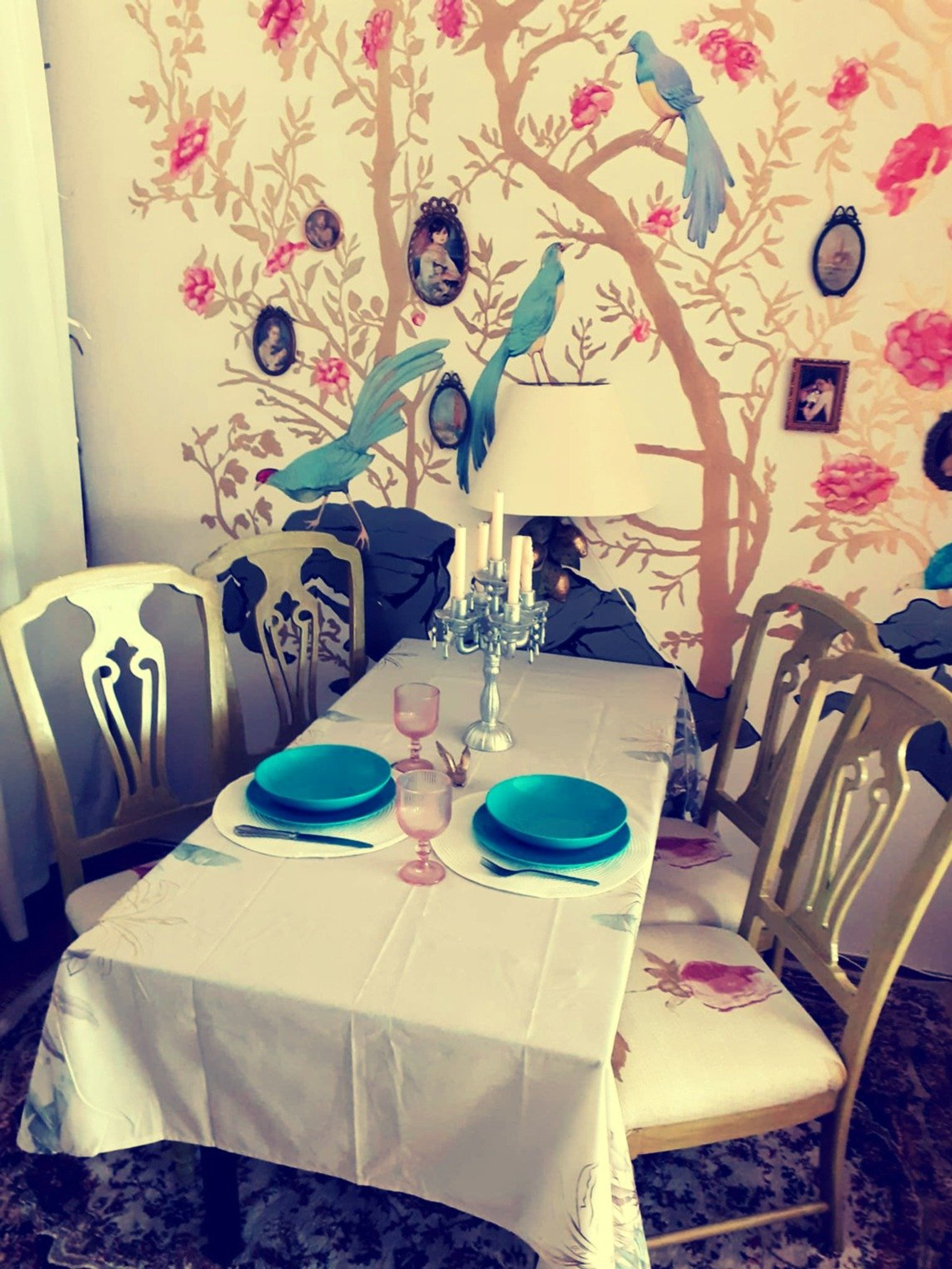 Elegant dining table with birds mural