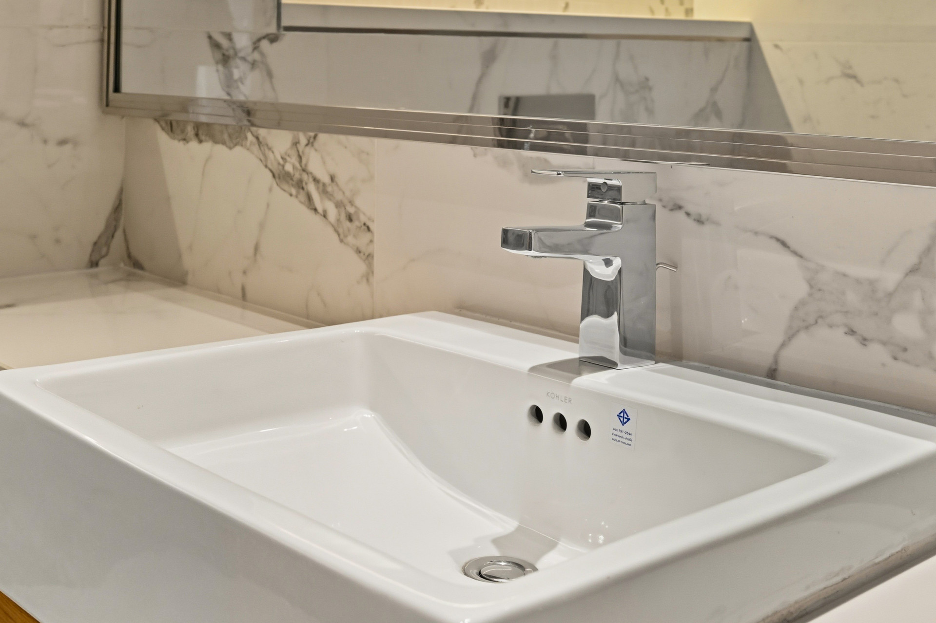 Modern bathroom sink with marble backdrop