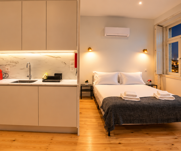 Studio kitchen and bed at dusk