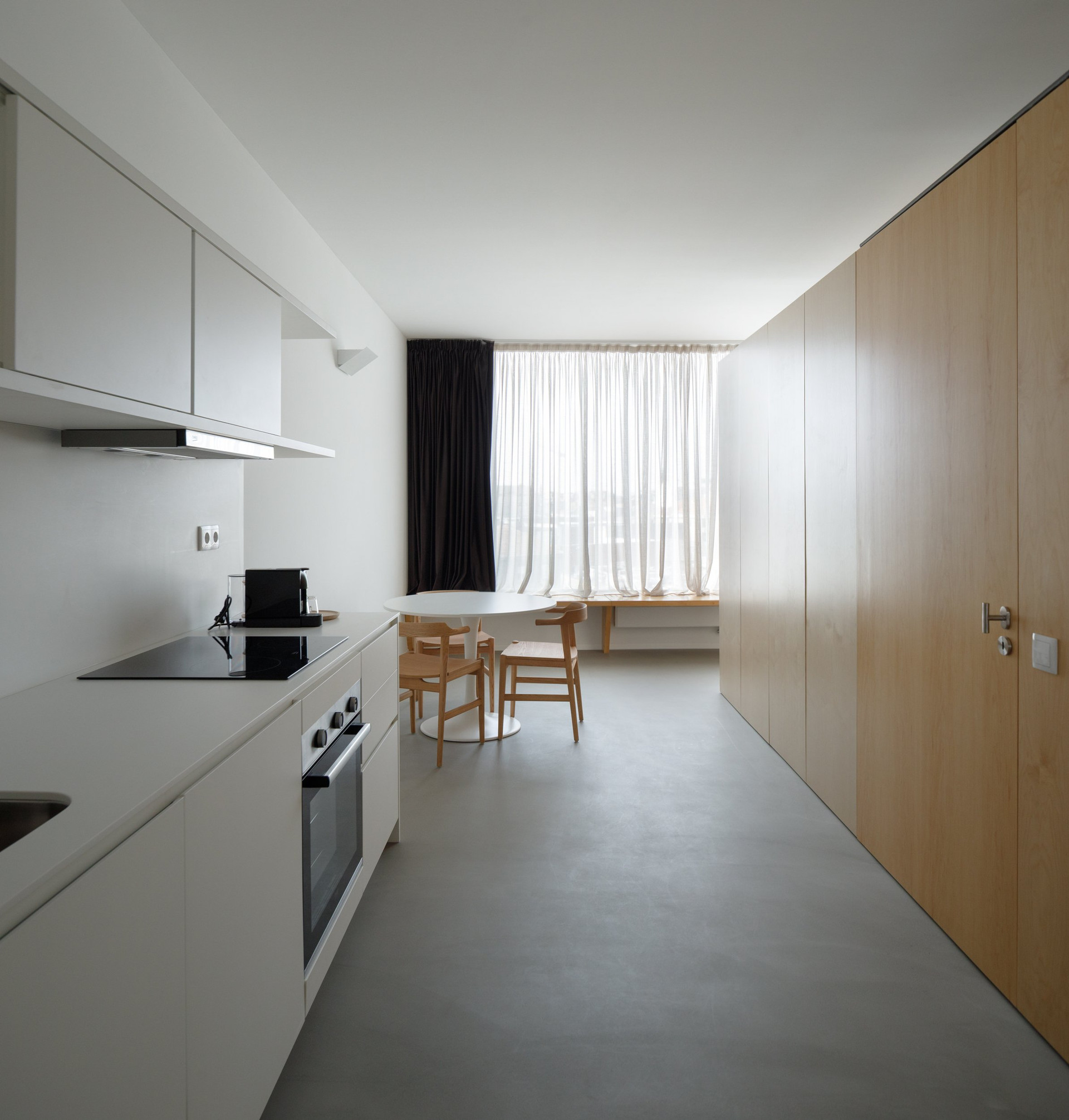 White kitchen with dining area beyond