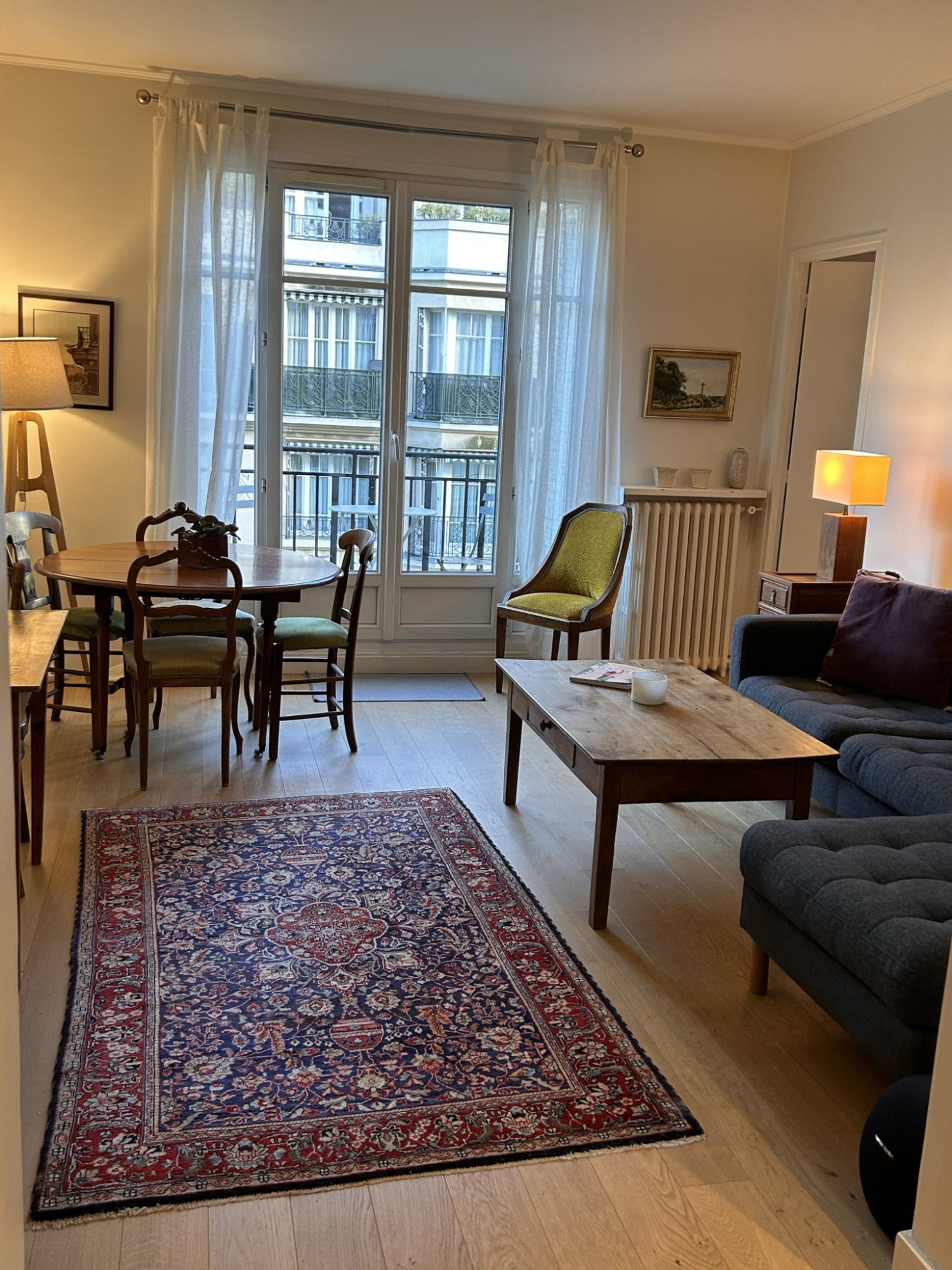 Living and dining room with TV set and large couch for additional sleeping