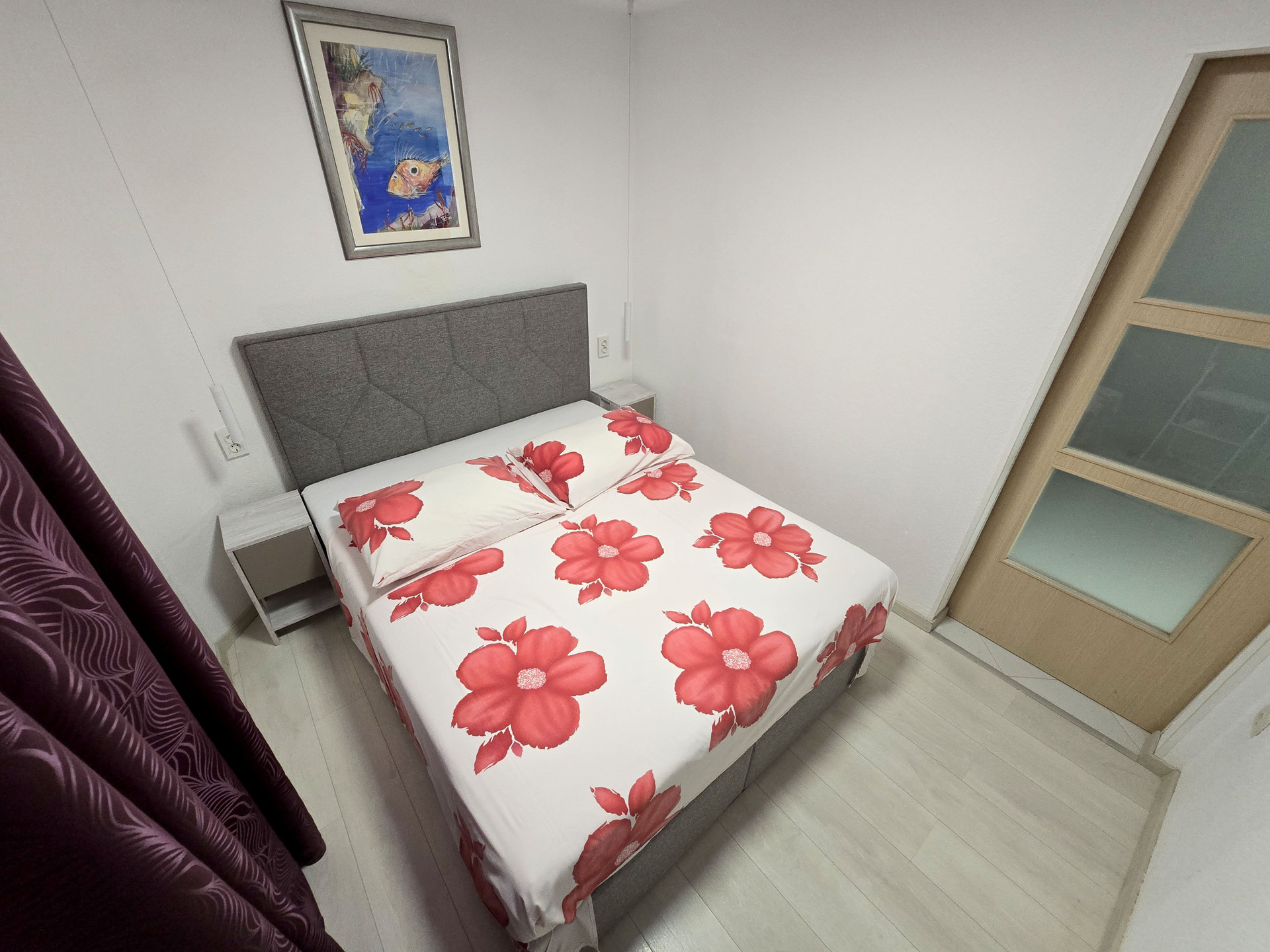 Bedroom with headboard and artwork