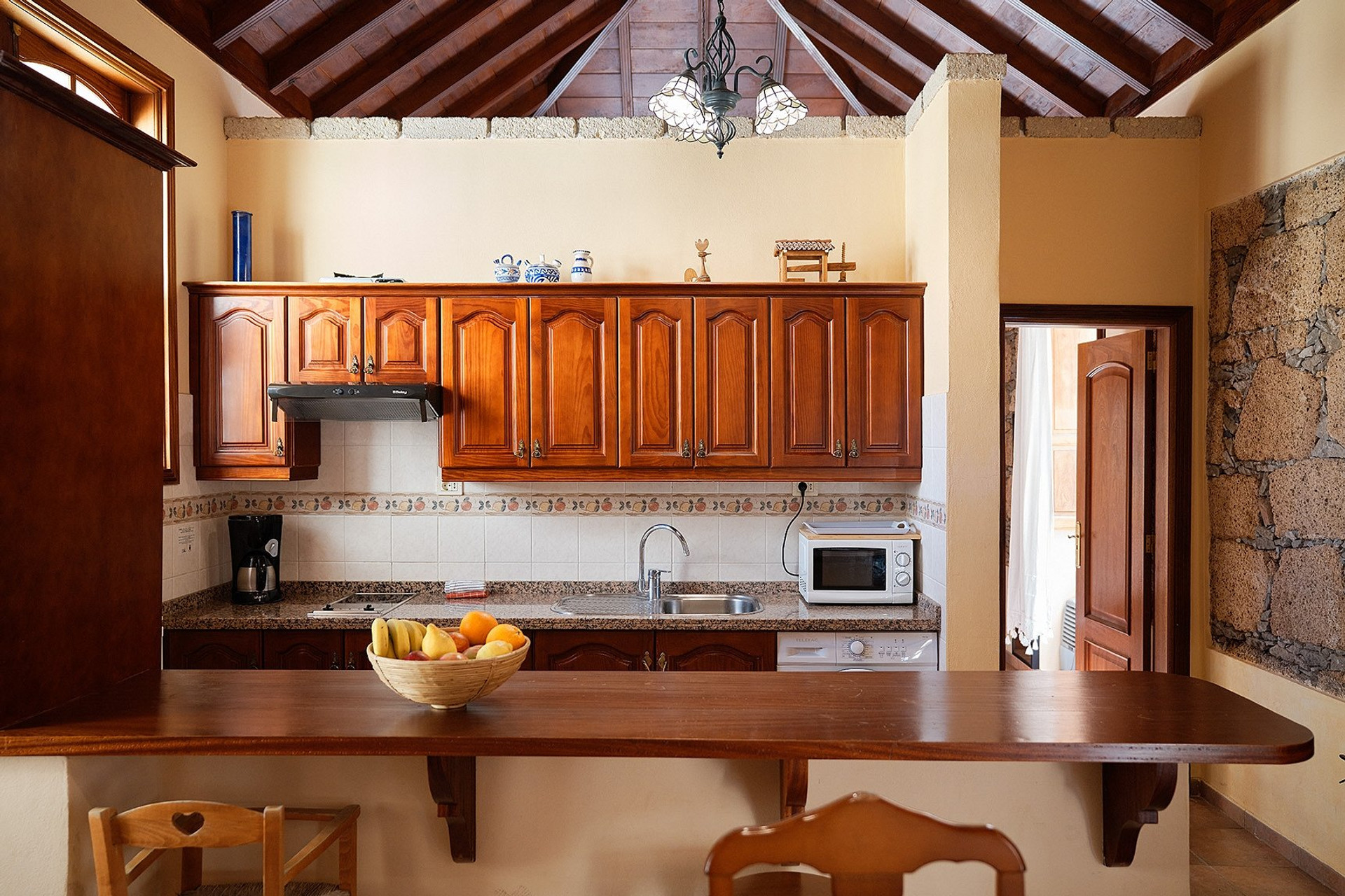 Kitchen with wooden cabinets and bar