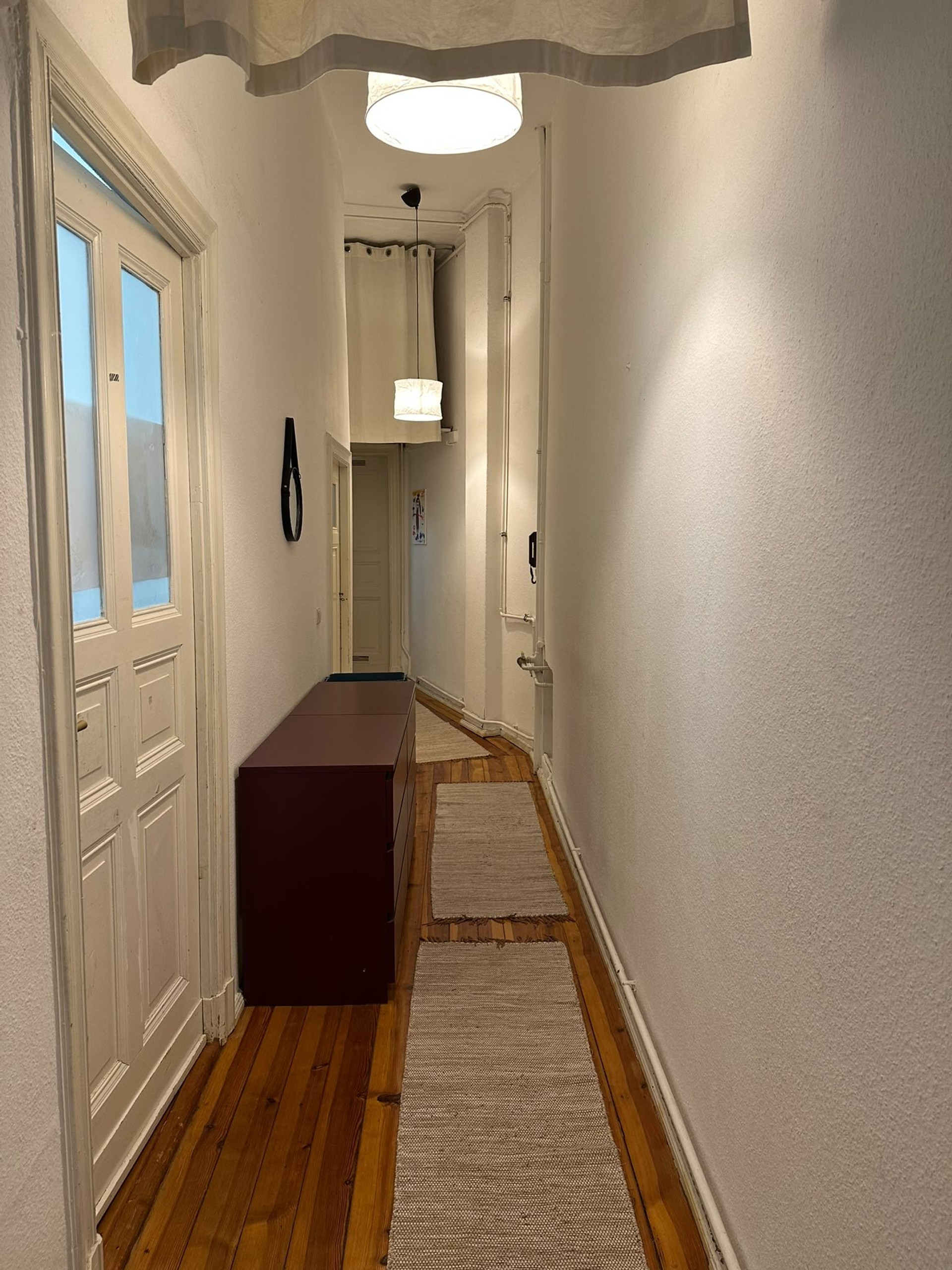 Narrow hallway with wooden floors