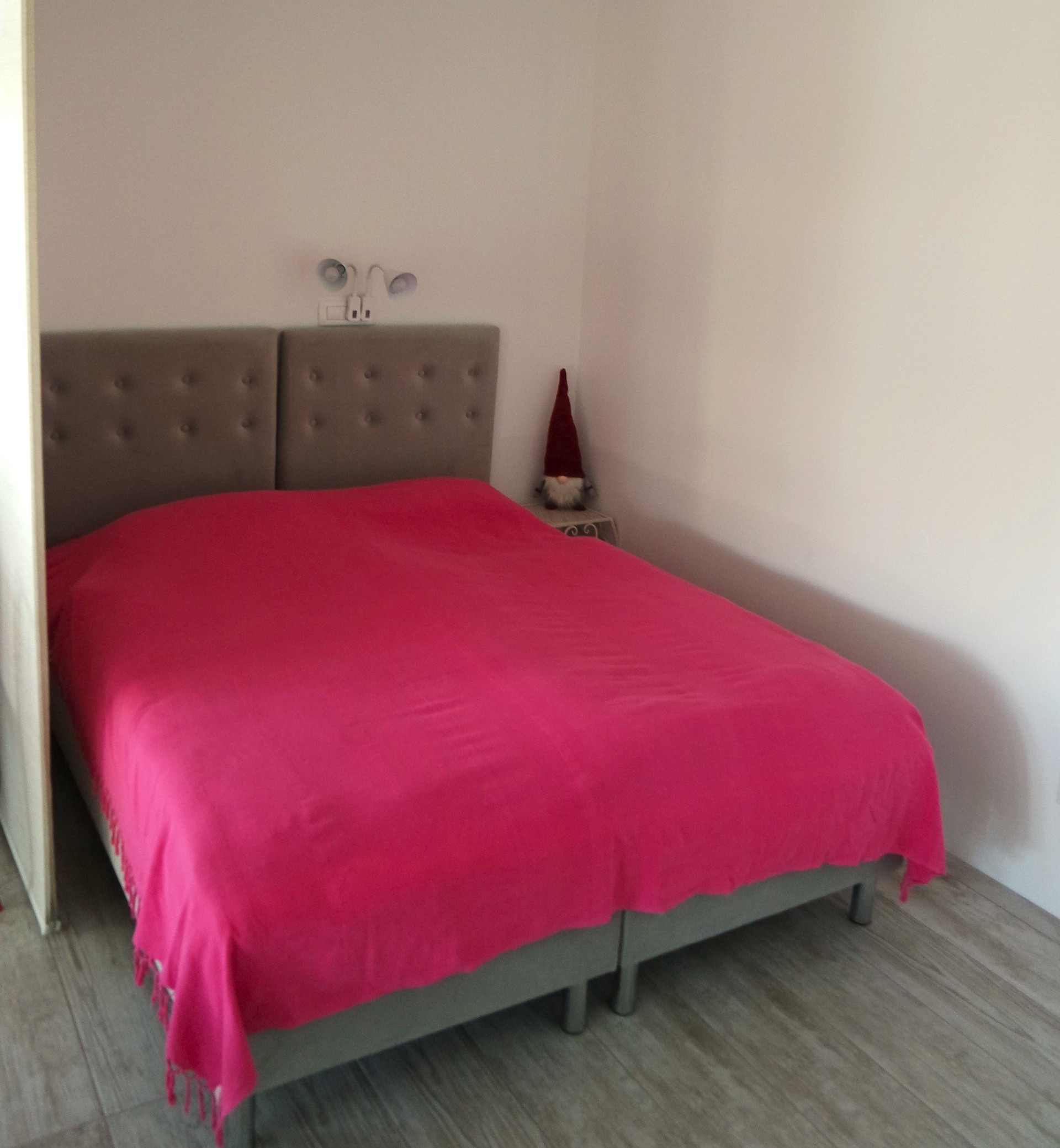 Bedroom with pink bedspread