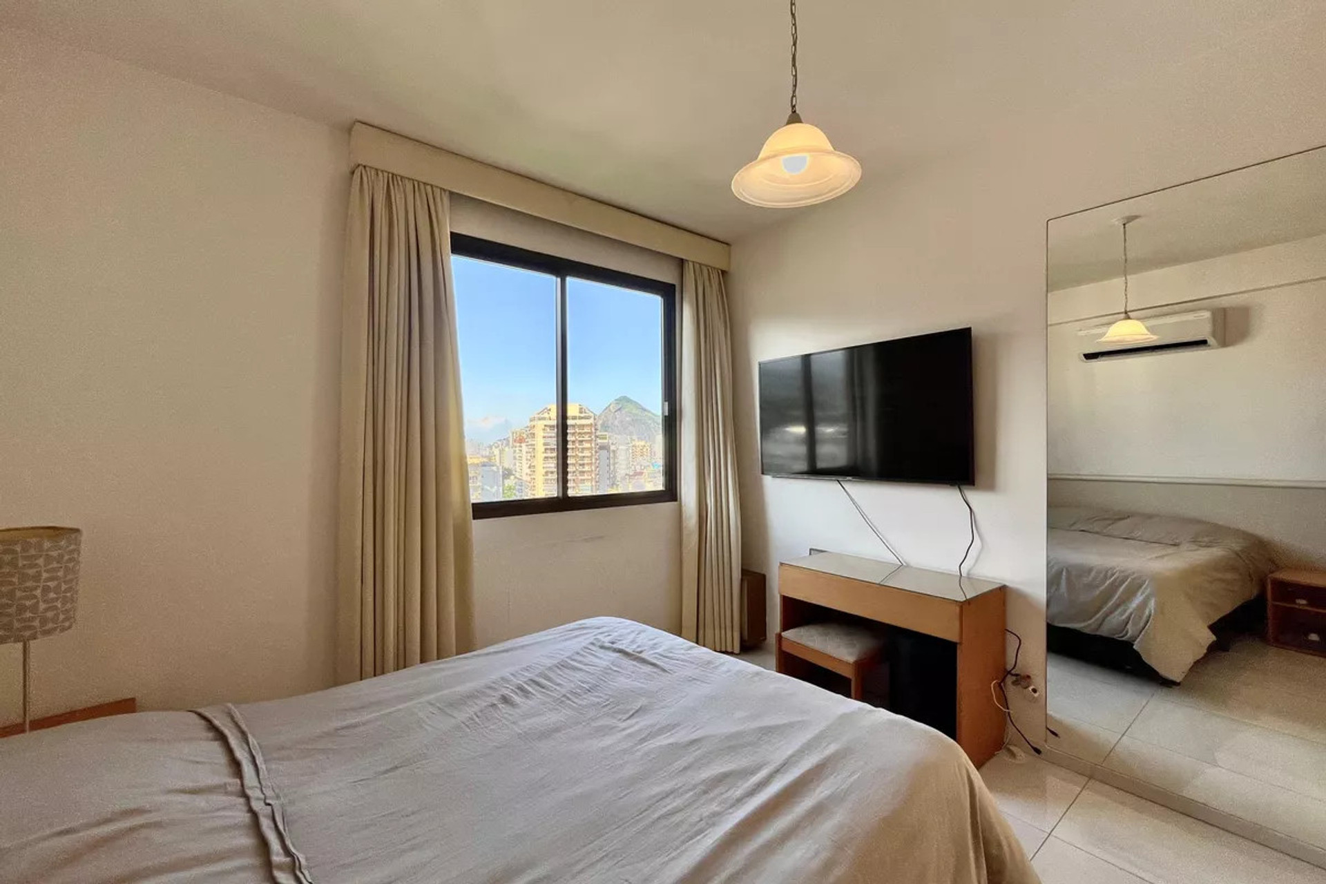 Bedroom with TV and mirror